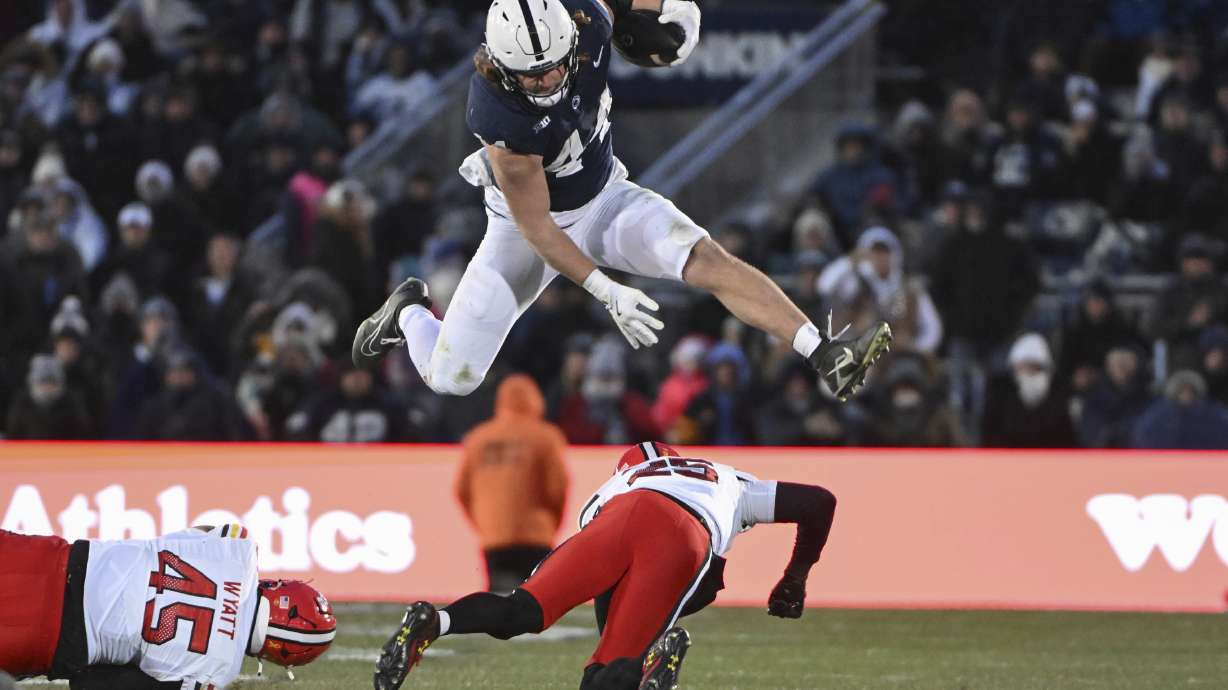 Penn State tight end Tyler Warren (44) hurdles Maryland defensive back Kevis Thomas (25) during the second quarter of an NCAA college football game, Saturday, Nov. 30, 2024, in State College, Pa.