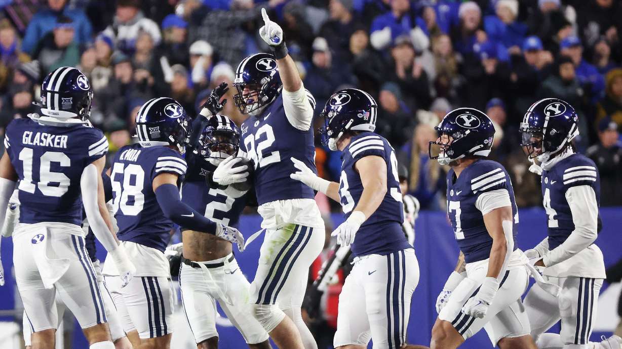 Brigham Young defensive end Tyler Batty (92) celebrates his interception against the Houston Cougars in Provo on Saturday, Nov. 30, 2024.