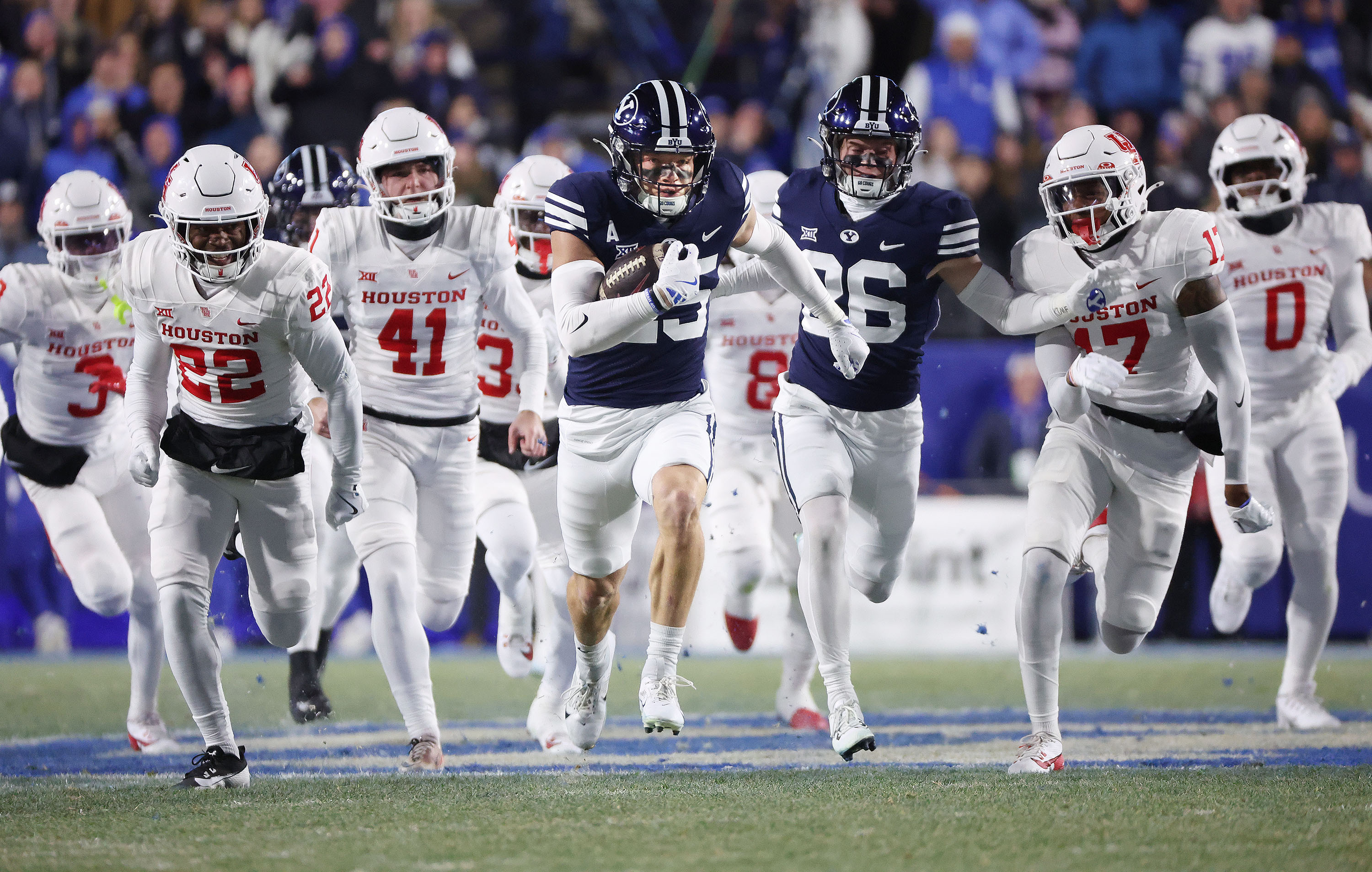 Brigham Young safety Talan Alfrey (25) runs back an onside kick off and scores against the Houston Cougars in Provo on Saturday, Nov. 30, 2024.