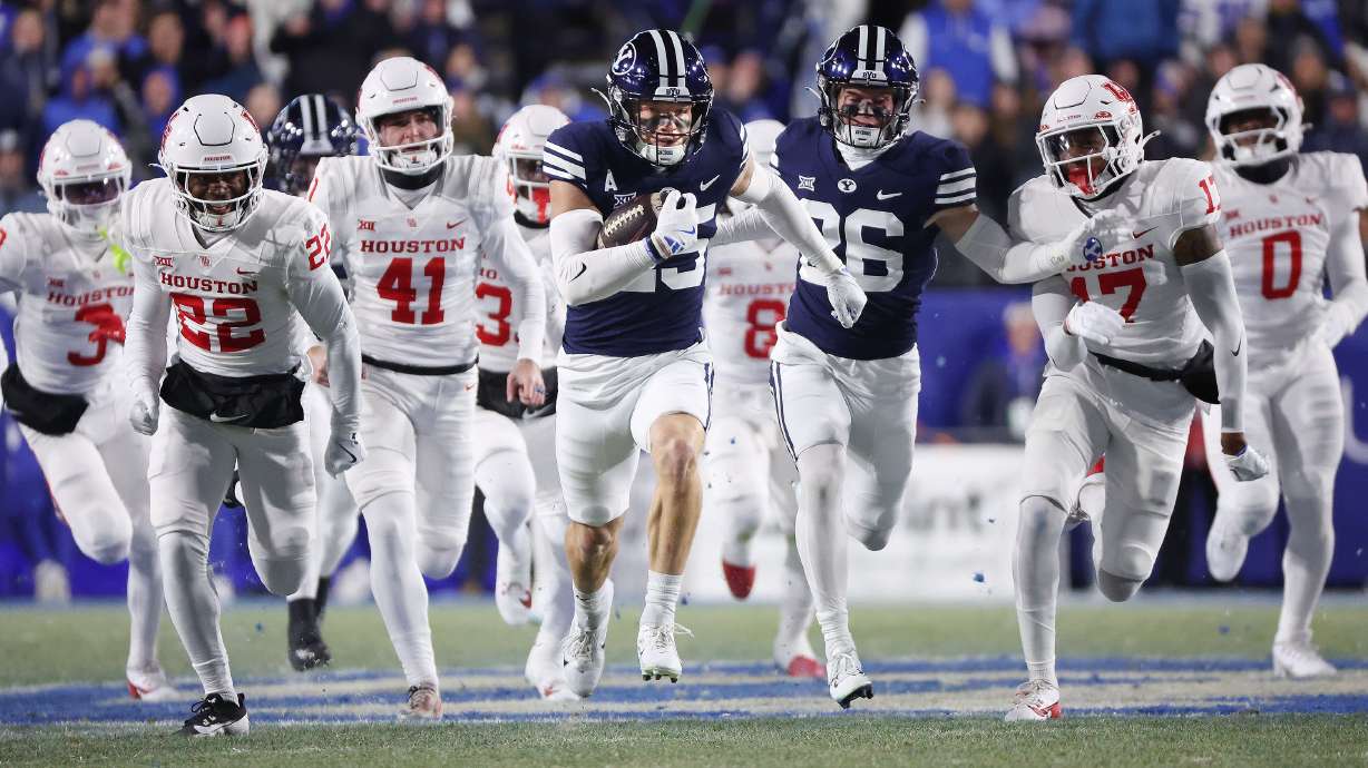Brigham Young Cougars safety Talan Alfrey (25) runs back an onside kick off and scores against the Houston Cougars in Provo on Saturday, Nov. 30, 2024.
