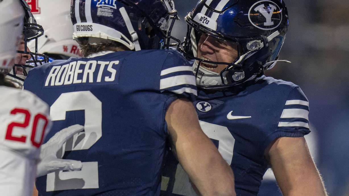 BYU wide receiver Chase Roberts (2) celebrates with BYU quarterback Jake Retzlaff, left, after Retzlaff scored a touchdown, during the first half of a NCAA college football game Saturday, Nov. 30, 2024, in Provo.