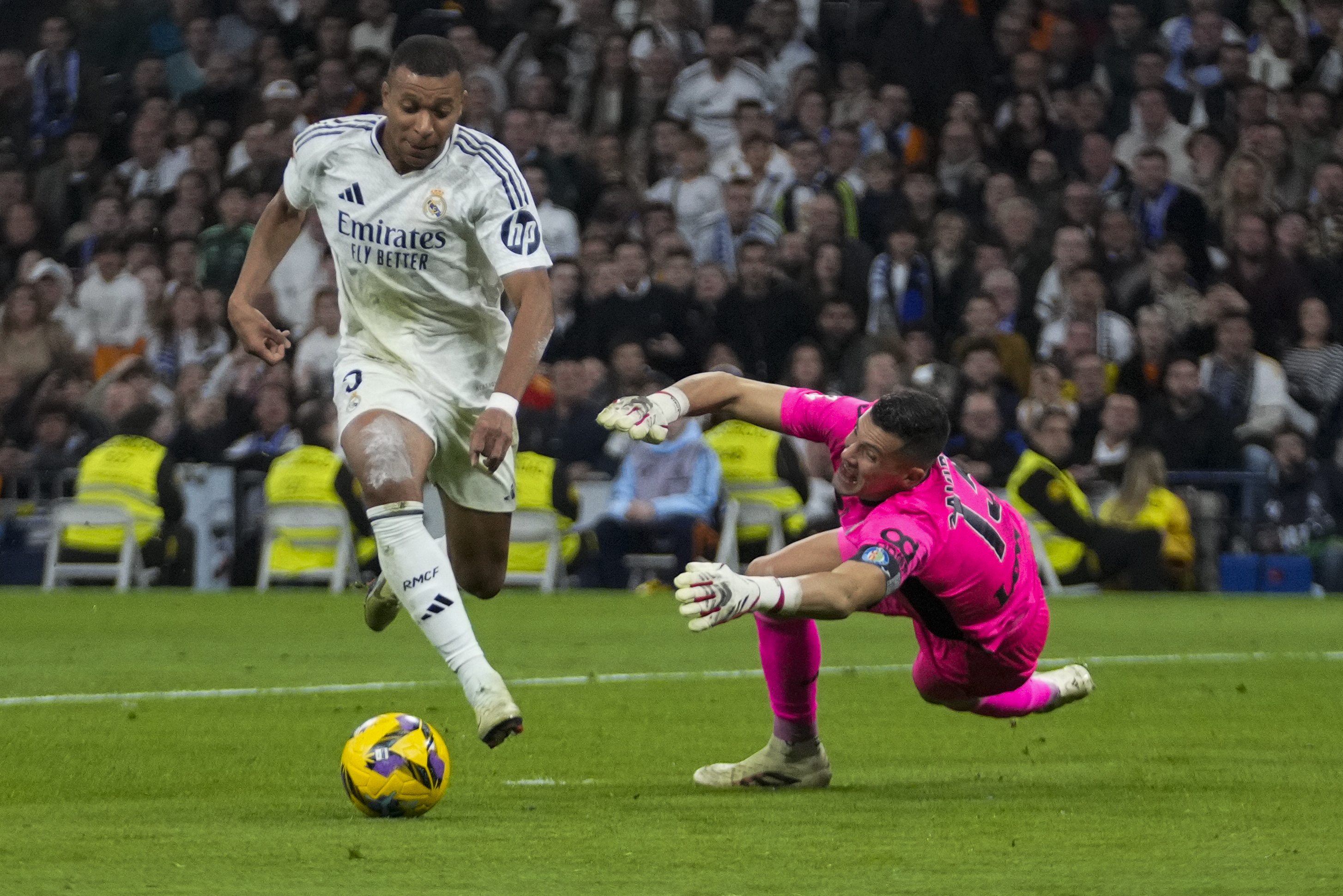Real Madrid's Kylian Mbappe runs with the ball in an attempt to score during the Spanish La Liga soccer match between Real Madrid and Getafe at the Santiago Bernabeu Stadium in Madrid, Spain, Sunday, Dec. 1, 2024.