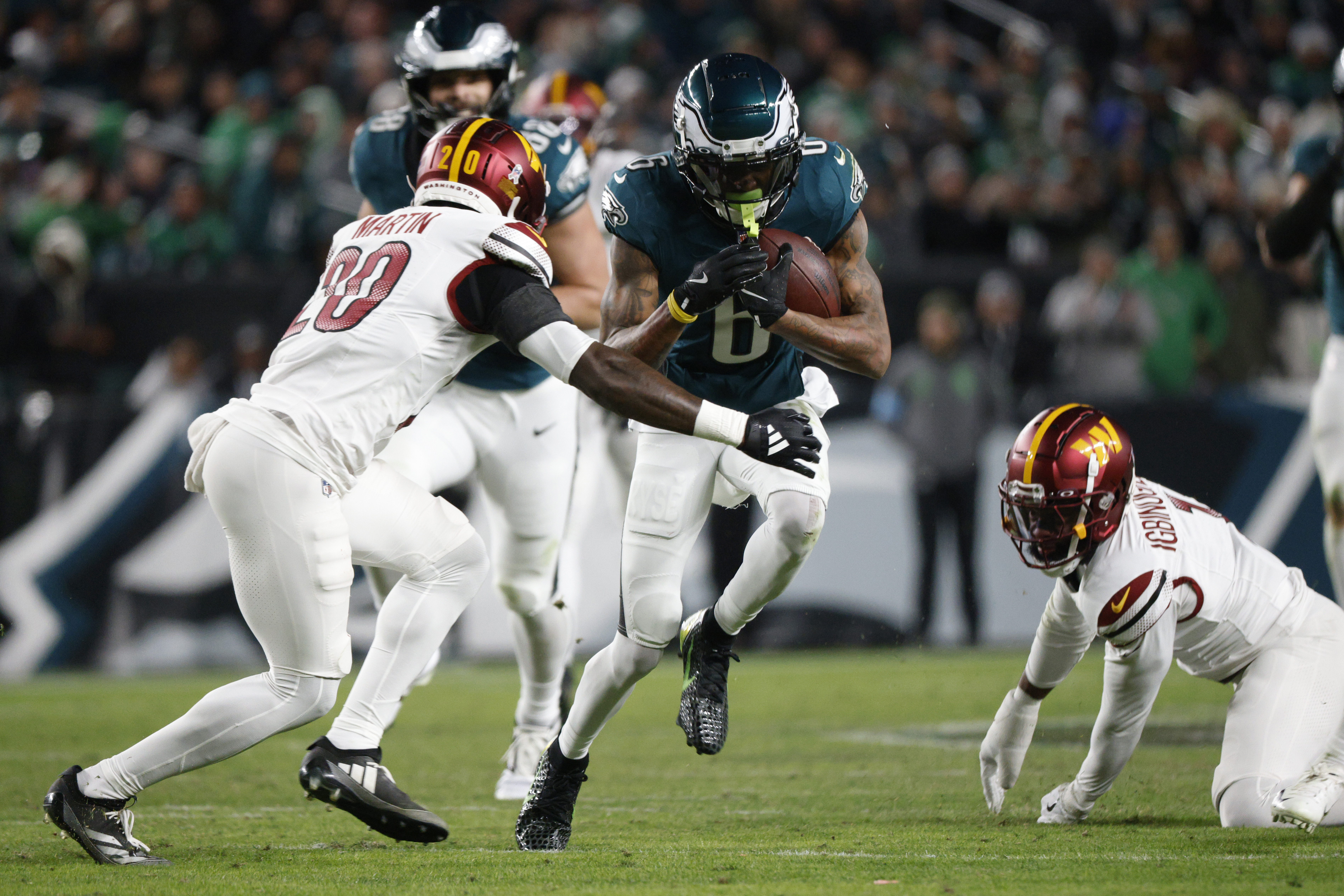 Philadelphia Eagles wide receiver DeVonta Smith (6) runs as Washington Commanders safety Quan Martin (20) defends during the first half of an NFL football game Thursday, Nov. 14, 2024, in Philadelphia.