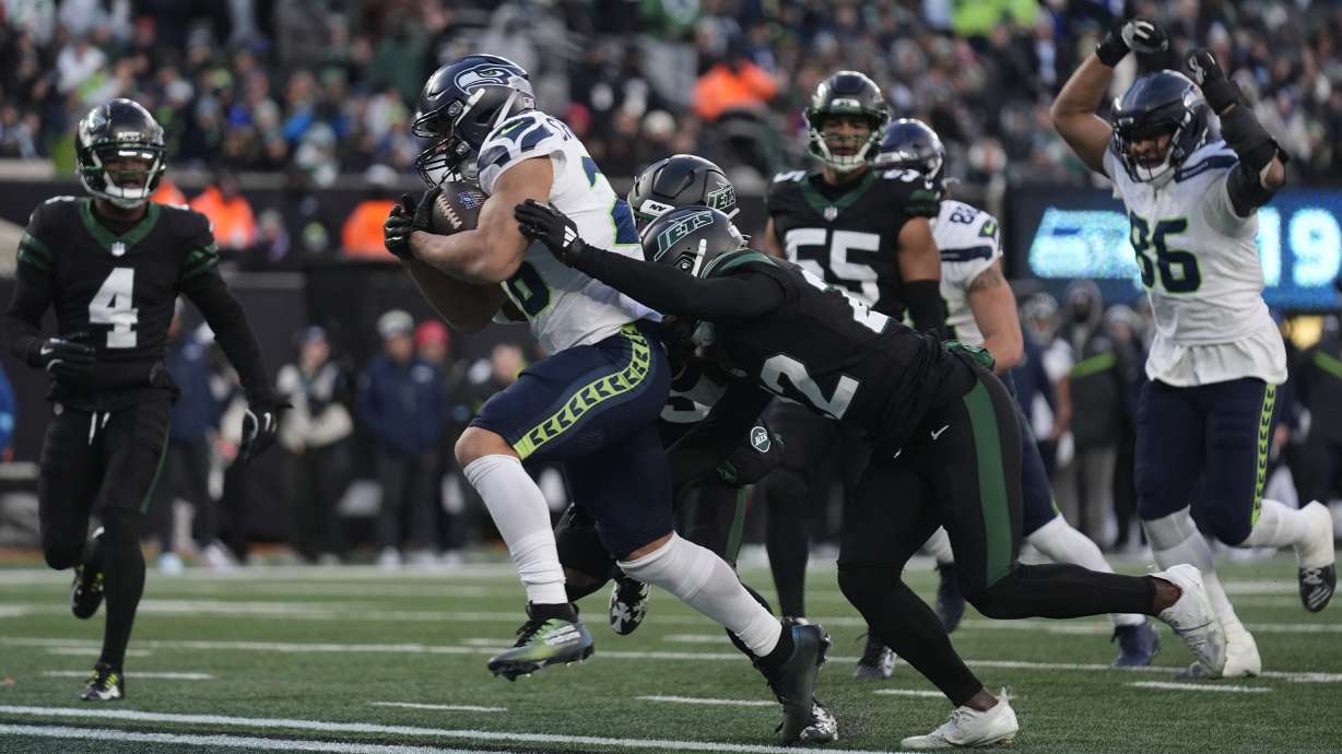 Seattle Seahawks running back Zach Charbonnet (26) crosses the goal line to score a touchdown against the New York Jets during the fourth quarter of an NFL football game, Sunday, Dec. 1, 2024, in East Rutherford, N.J.