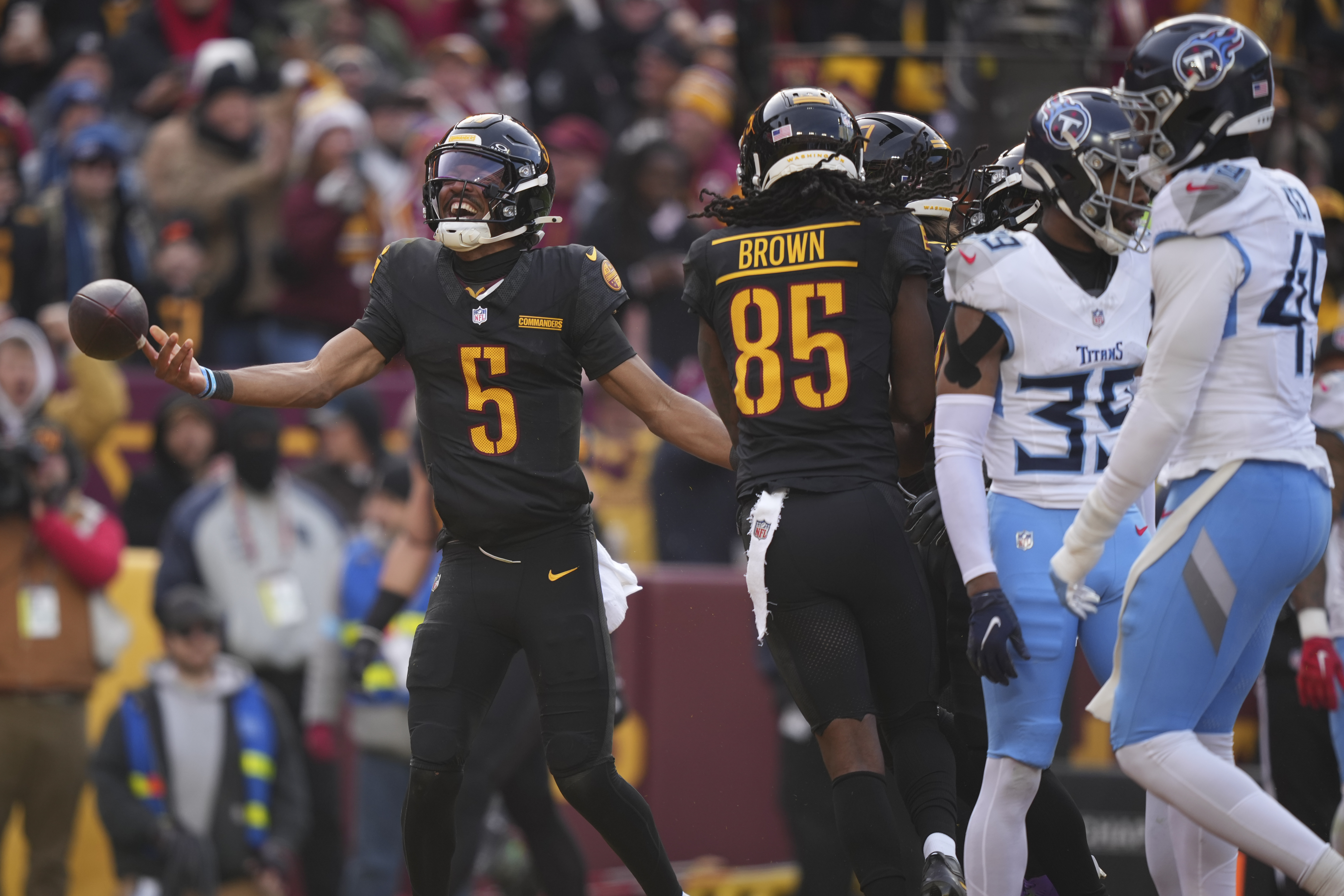 Washington Commanders quarterback Jayden Daniels (5) celebrates his touchdown during the first half of an NFL football game against the Tennessee Titans, Sunday, Dec. 1, 2024, in Landover, Md. 