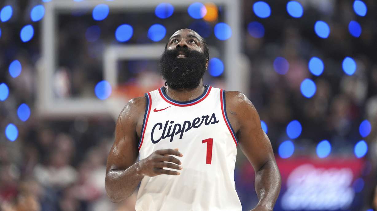 Los Angeles Clippers guard James Harden looks toward the scoreboard after making a three-point shot that put him at 2,998 points for three-point shots during the first half of an NBA basketball game against the Denver Nuggets, Sunday, Dec. 1, 2024, in Inglewood, Calif.