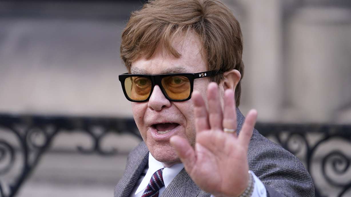 Elton John waves to the waiting media as he leaves the Royal Courts Of Justice in London, March 27, 2023. John said Sunday he struggled to watch his new musical because he has lost his eyesight.