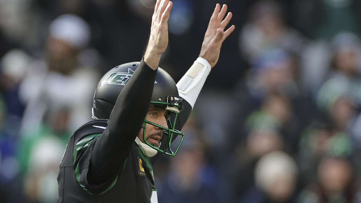 New York Jets quarterback Aaron Rodgers (8) reacts after throwing a touchdown pass against the Seattle Seahawks during the first quarter of an NFL football game, Sunday, Dec. 1, 2024, in East Rutherford, N.J.