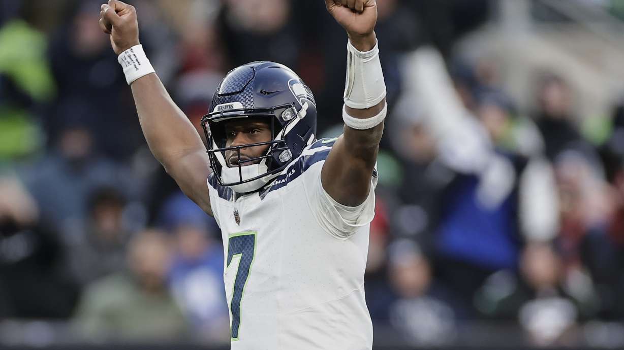 Seattle Seahawks quarterback Geno Smith (7) reacts after a touchdown by running back Zach Charbonnet during the fourth quarter of an NFL football game against the New York Jets, Sunday, Dec. 1, 2024, in East Rutherford, N.J.