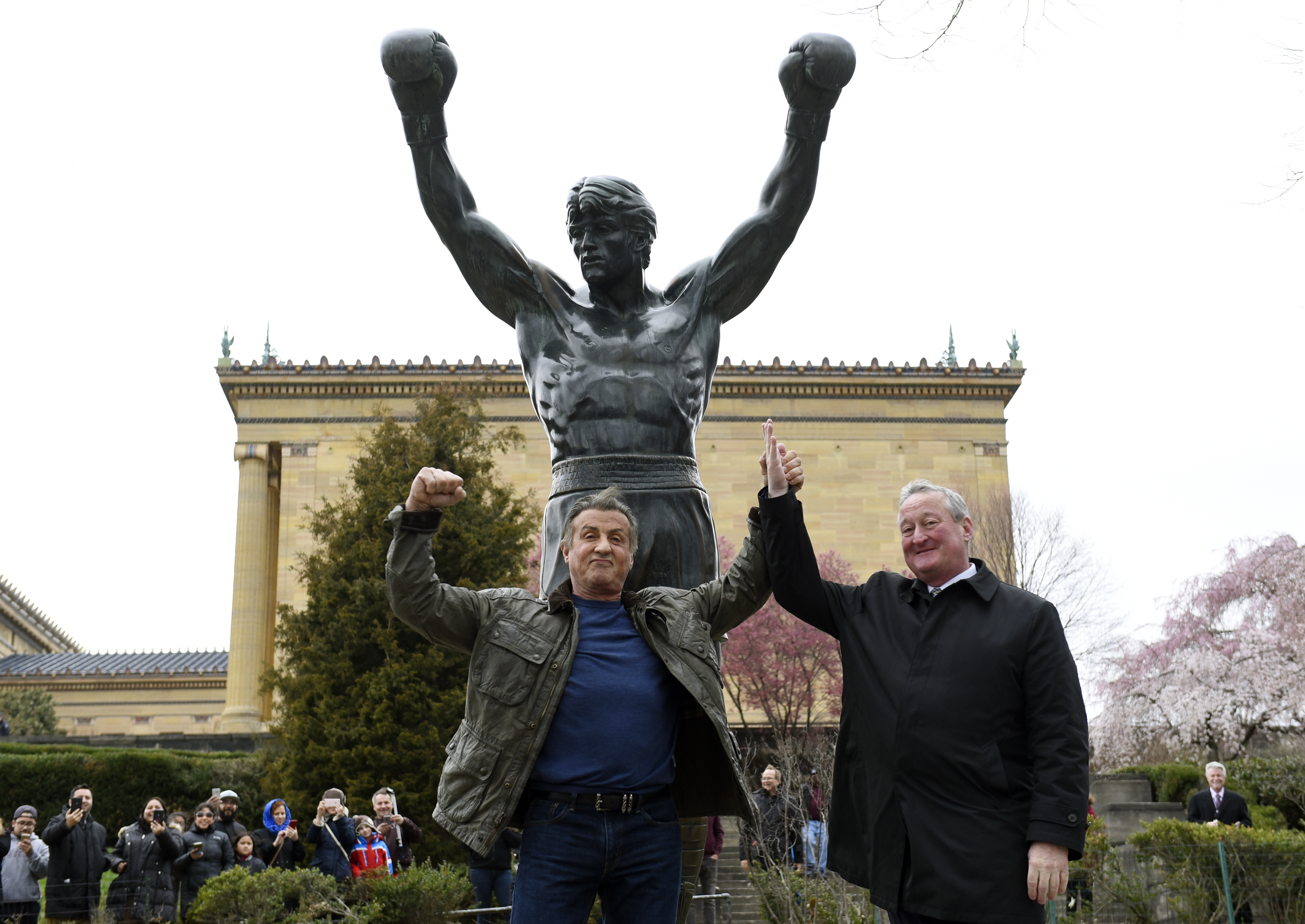 FILE - Sylvester Stallone, left, poses with Philadelphia Mayor Jim Kenney in front of the Rocky statue at the Philadelphia Art Museum for a "Creed II" photo op, Friday, April 6, 2018, in Philadelphia.