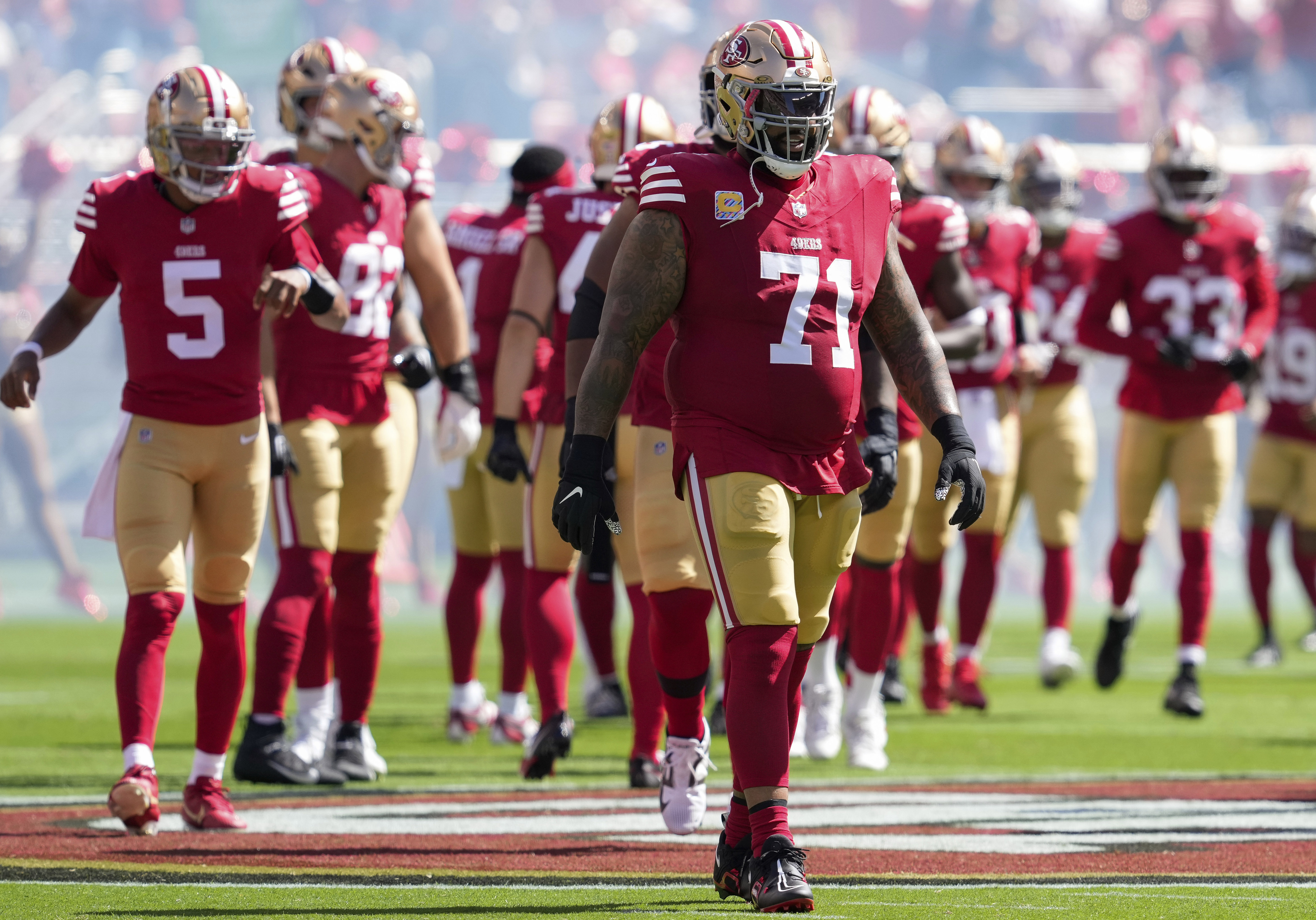FILE - San Francisco 49ers offensive tackle Trent Williams (71) and teammates take the field for an NFL football game against the New England Patriots, Sept. 29, 2024, in Santa Clara, Calif.