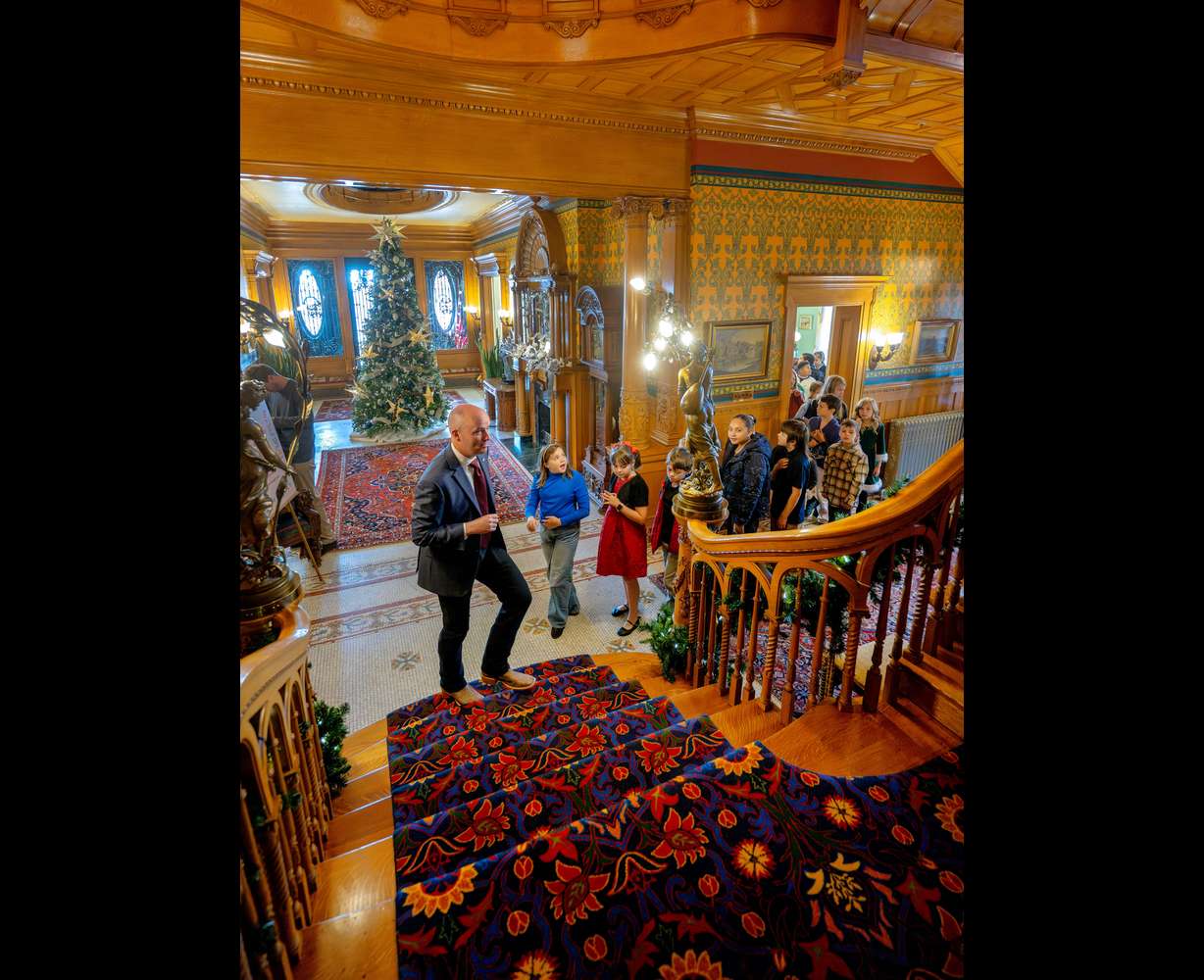 Gov. Spencer Cox leads a tour as he and first lady Abby Cox welcome kids from Polk Elementary in Ogden into the Governor's Mansion in Salt Lake City on Monday to decorate a Christmas tree and mantel.