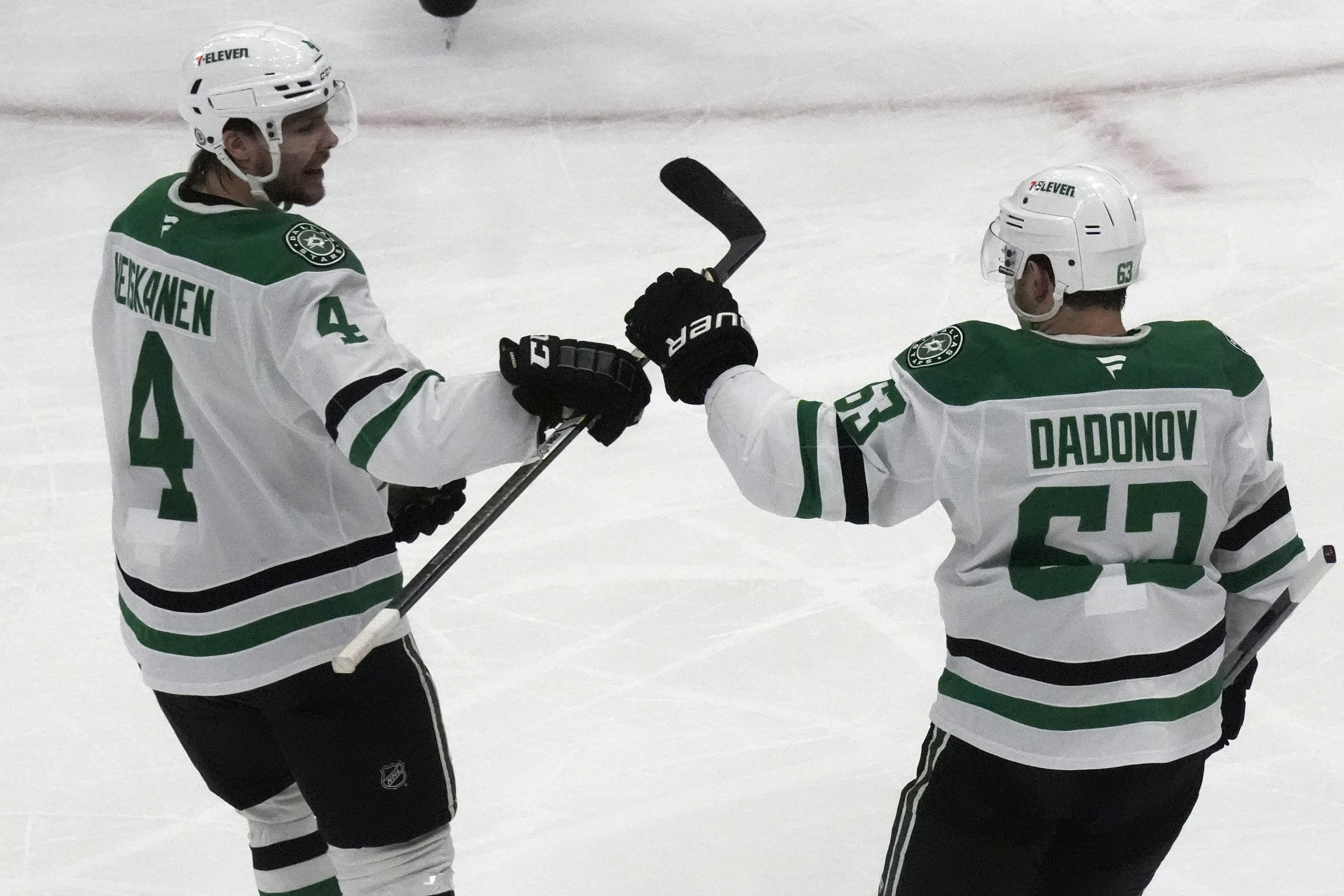 Dallas Stars right wing Evgenii Dadonov (63) celebrates with teammate Miro Heiskanen (4) after scoring against the Utah Hockey Club during the second period of an NHL hockey game Monday, Dec. 2, 2024, in Salt Lake City.