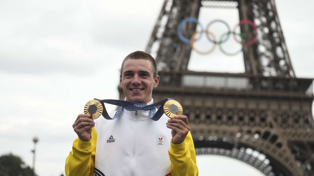 FILE -Remco Evenepoel, of Belgium, shows his gold medals of the men's time trial and road cycling events, at the 2024 Summer Olympics, Saturday, Aug. 3, 2024, in Paris, France.