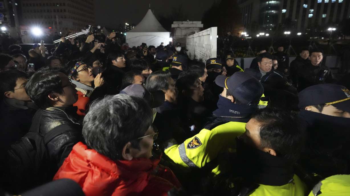People try to enter as police officers stand guard in front of the National Assembly in Seoul, South Korea, Tuesday. South Korean President Yoon Suk Yeol’s government early Wednesday lifted the martial law he imposed during a tense night of political drama.
