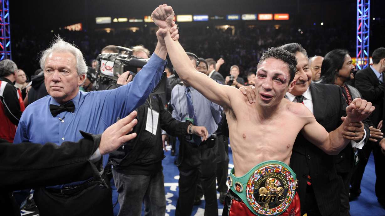 FILE - Referee Pat Russell raises the arm of Israel Vázquez of Mexico after he defeated Rafael Marquez of Mexico in their WBC super bantamweight championship bout, in Carson, Calif., March. 1, 2008. The World Boxing Council (WBC) president confirmed on Tuesday, Dec. 3, 2024, that Israel Vázquez, a Mexican fighter who won three world titles in his boxing career, has died. He was 46.