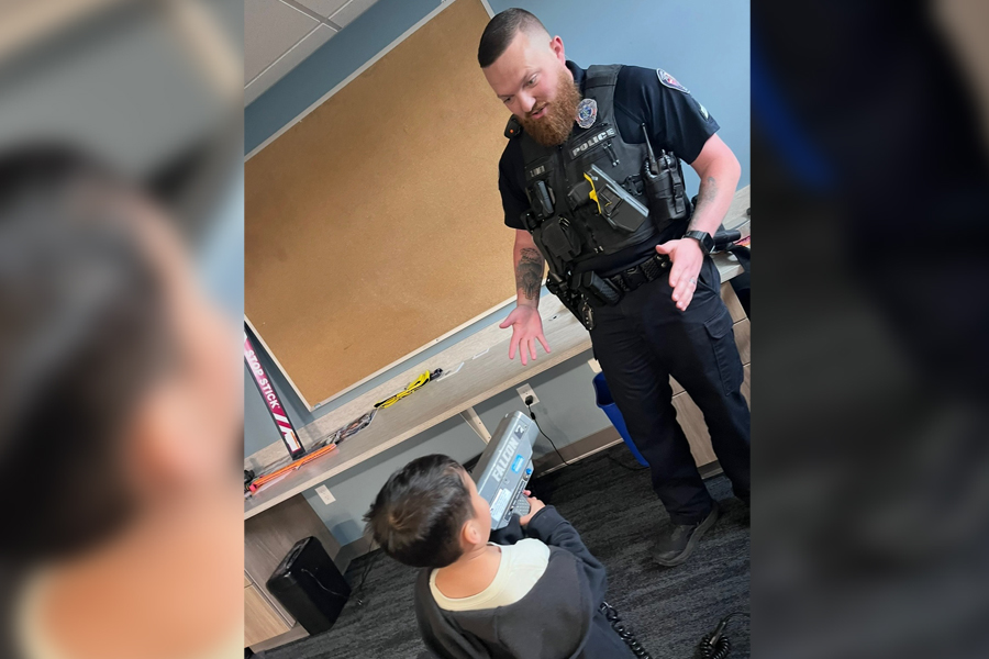 River Elquezabal, left, tries out Sgt. Tyler Hoffa’s radar gun during his visit to the Chubbuck, Idaho, police station in this undated photo.