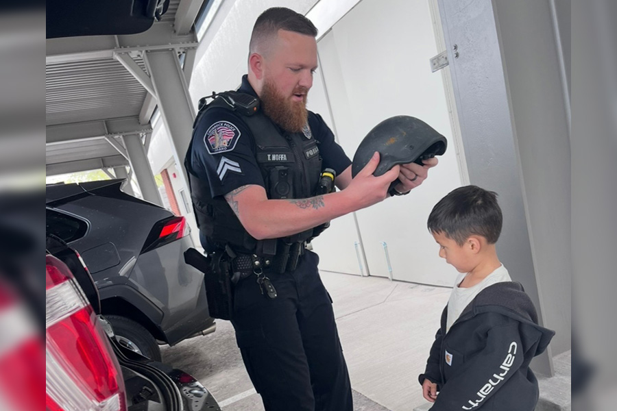 River Elquezabal tries on Chubbuck police Sgt. Tyler Hoffa’s gear at the police station in Chubbuck, Idaho, in this undated photo.