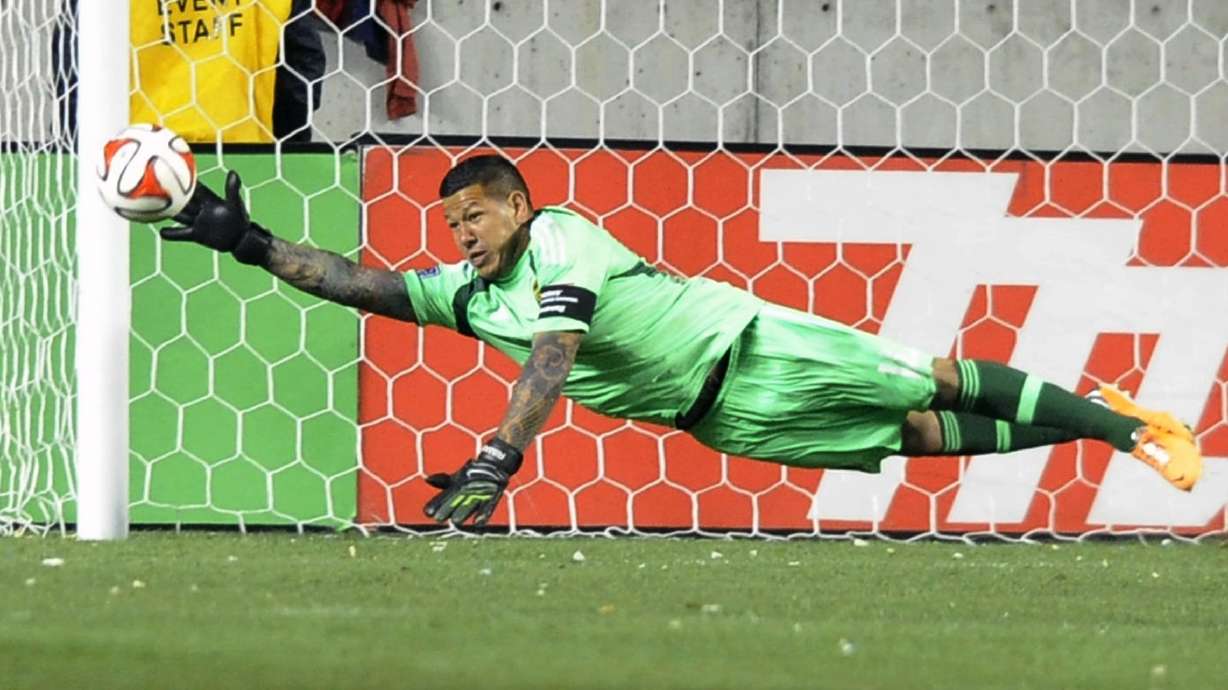Real Salt Lake goalkeeper Nick Rimando (18) makes a diving save during a game at Rio Tinto Stadium in Sandy on Saturday, March 29, 2014.