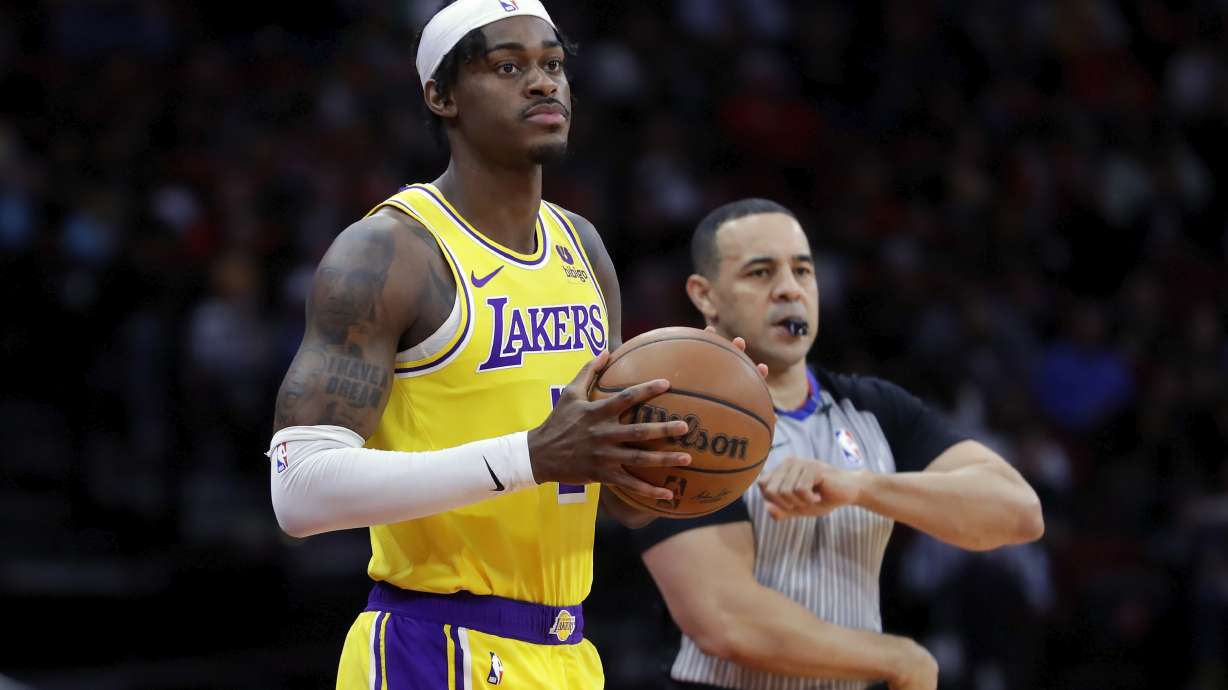 FILE - Los Angeles Lakers forward Jarred Vanderbilt, left, throws in the ball next to referee Curtis Blair, right, during the first half of an NBA basketball game, Jan. 29, 2024, in Houston.