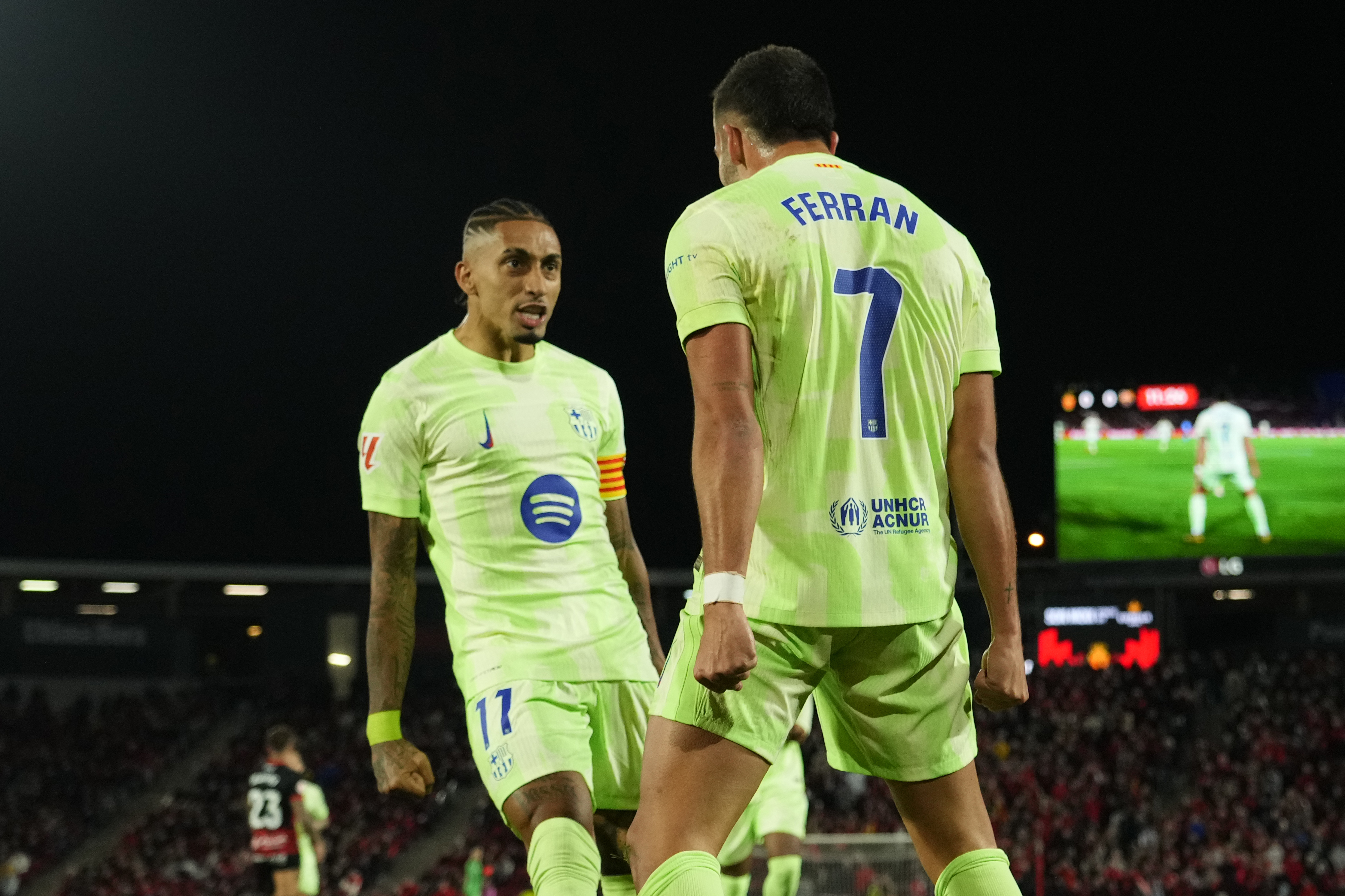 Barcelona's Ferran Torres, right, celebrates with Raphinha after scoring the opening goal during a Spanish La Liga soccer match between Mallorca and Barcelona at the Son Moix stadium in Palma de Mallorca, Spain, Tuesday, Dec. 3, 2024.