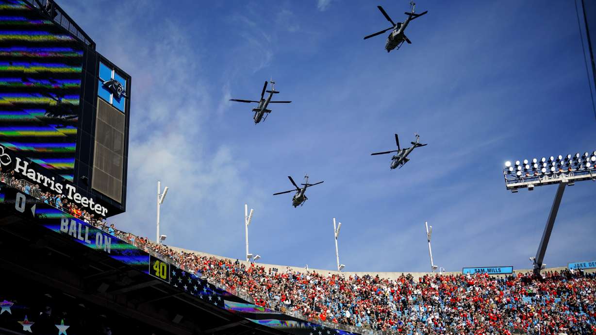 U.S. Marine Light Attack Helicopter Squadron 269 flies over Bank of America Stadium before an NFL football game between the Carolina Panthers and the Kansas City Chiefs, Sunday, Nov. 24, 2024, in Charlotte, N.C.