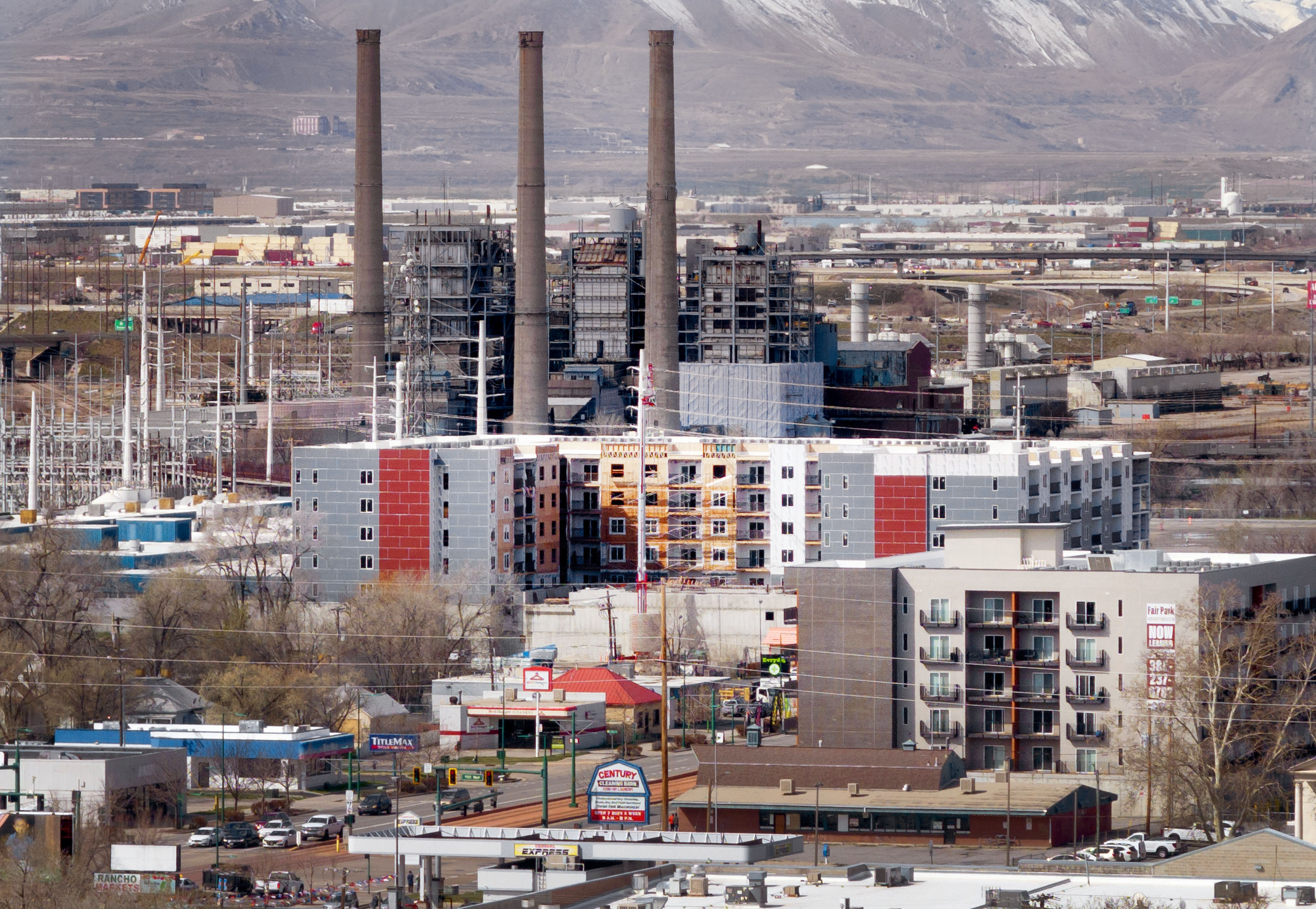 Construction of apartment buildings and condominiums is pictured near the Rocky Mountain Power’s smokestacks in Salt Lake City on March 27. The North Temple corridor, where the TRAX Green Line runs through, is one of the city's fast-growing development areas with many new housing projects over the past decade.