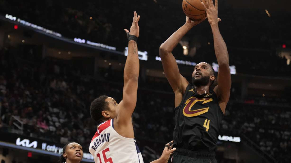 Cleveland Cavaliers forward Evan Mobley (4) shoots over Washington Wizards guard Malcolm Brogdon (15) in the first half of an NBA Cup basketball game, Tuesday, Dec. 3, 2024, in Cleveland.