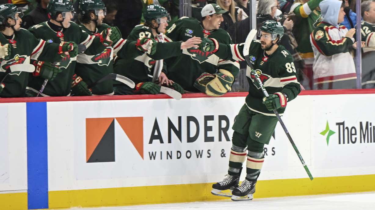 Minnesota Wild center Frederick Gaudreau celebrates with the bench after scoring a goal against the Vancouver Canucks during the second period of an NHL hockey game Tuesday, Dec. 3, 2024, in St. Paul, Minn.