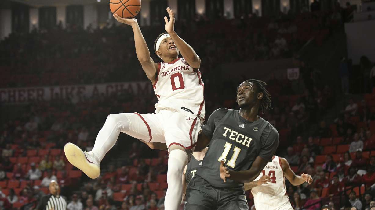Oklahoma guard Jeremiah Fears (0) shoots over georgia Tech forward Baye Ndongo (11) during the first half of an NCAA college basketball game, Tuesday, Dec. 3, 2024, in Norman, Okla.