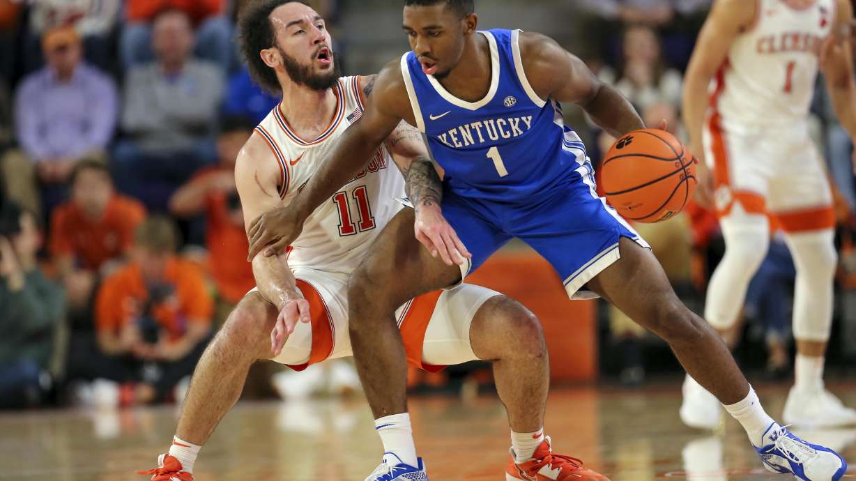 Clemson guard Jaeden Zackery (11) defends Kentucky guard Lamont Butler (1) during the first half of an NCAA college basketball game, Tuesday, Dec. 3, 2024, in Clemson, S.C.