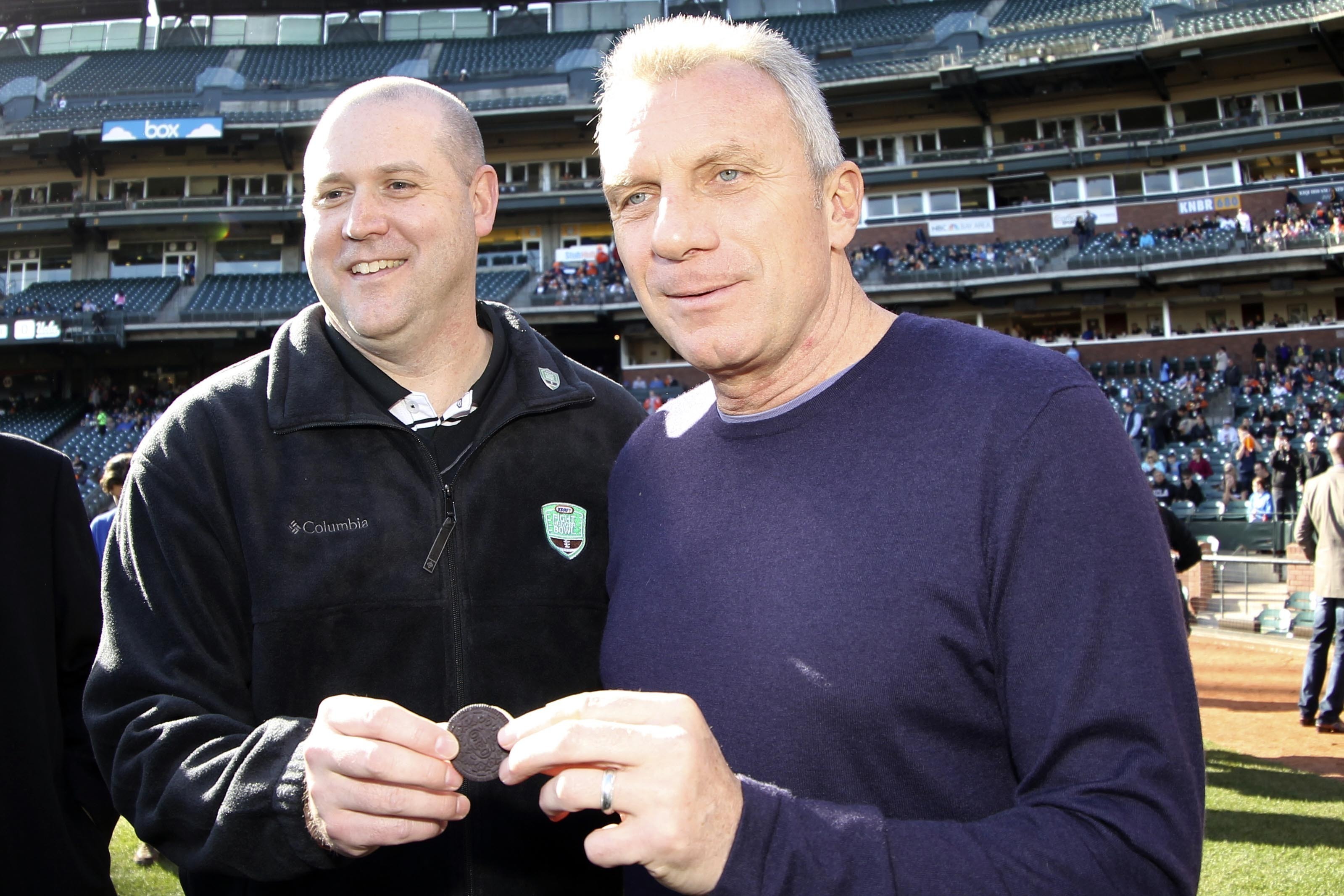 FILE - Football great Joe Montana, right, and Mark Clouse, President, Kraft Foods Snacks & Confectionery pose in San Francisco, on Dec. 31, 2011.