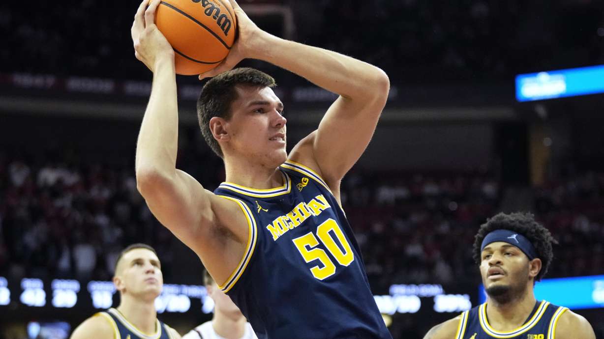 Michigan center Vlad Goldin (50) rebounds the ball during the second half of an NCAA college basketball game against Wisconsin Tuesday, Dec. 3, 2024, in Madison, Wis. Michigan won 67-64.