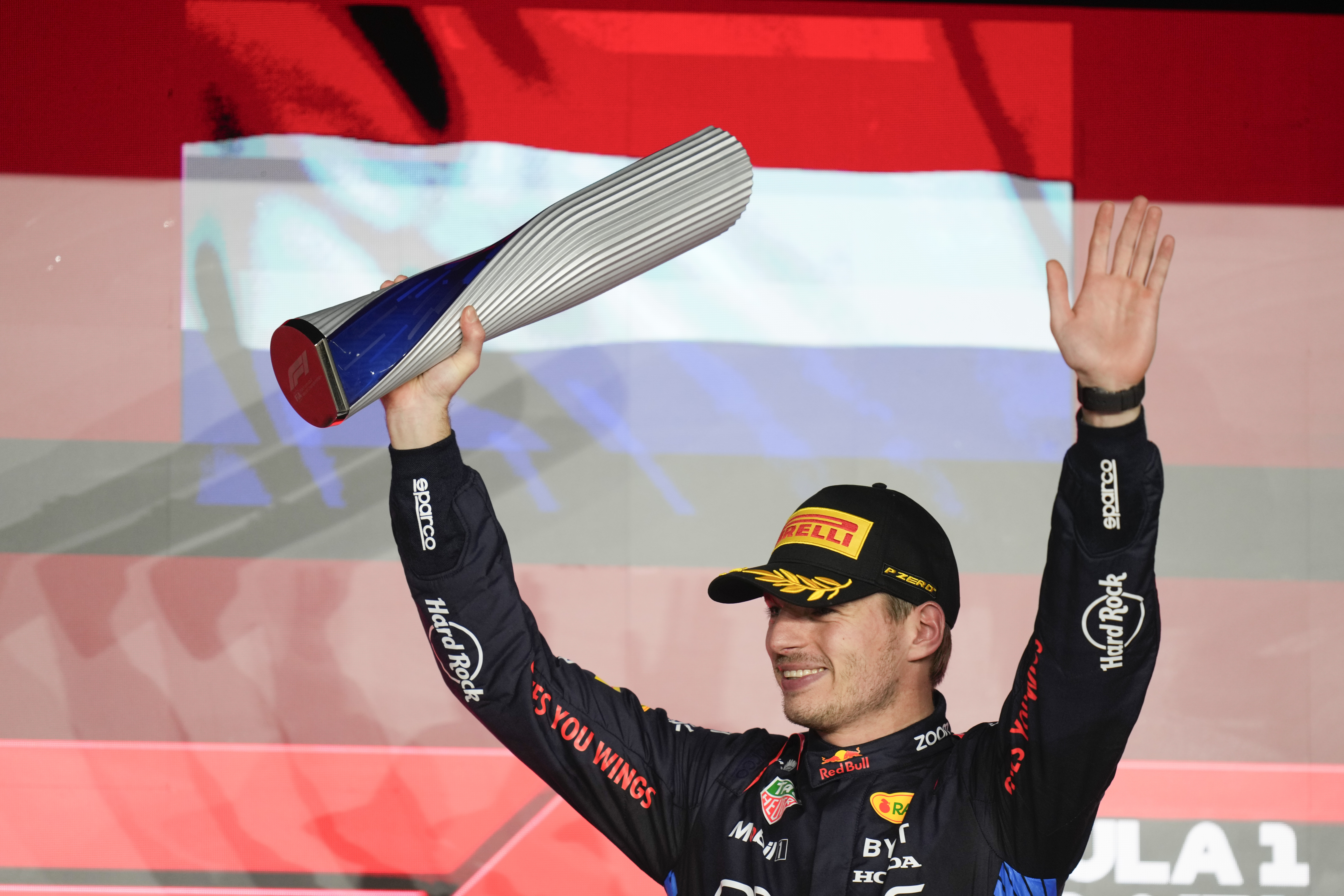 Red Bull driver Max Verstappen of the Netherlands stands on the podium after winning the Qatar Formula One Grand Prix at the Lusail International Circuit in Lusail, Qatar, Sunday, Dec. 1, 2024.