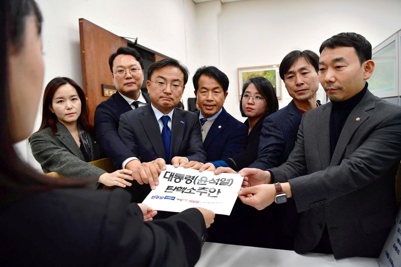 South Korean lawmakers submit a impeachment motion of South Korean President Yoon Suk Yeol at the National Assembly in Seoul, South Korea, Wednesday.