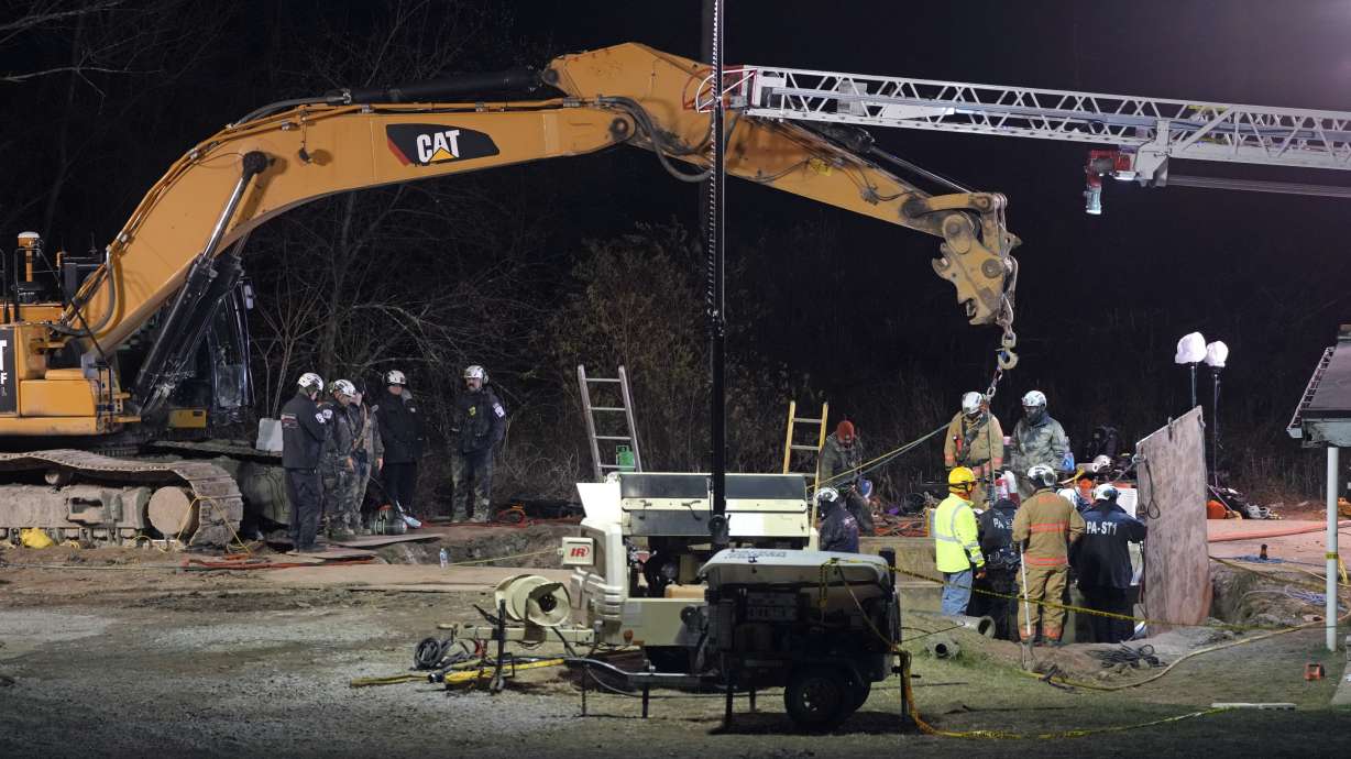 Rescue workers search through the night in a sinkhole for Elizabeth Pollard, who disappeared while looking for her cat, in Marguerite, Pa., Tuesday