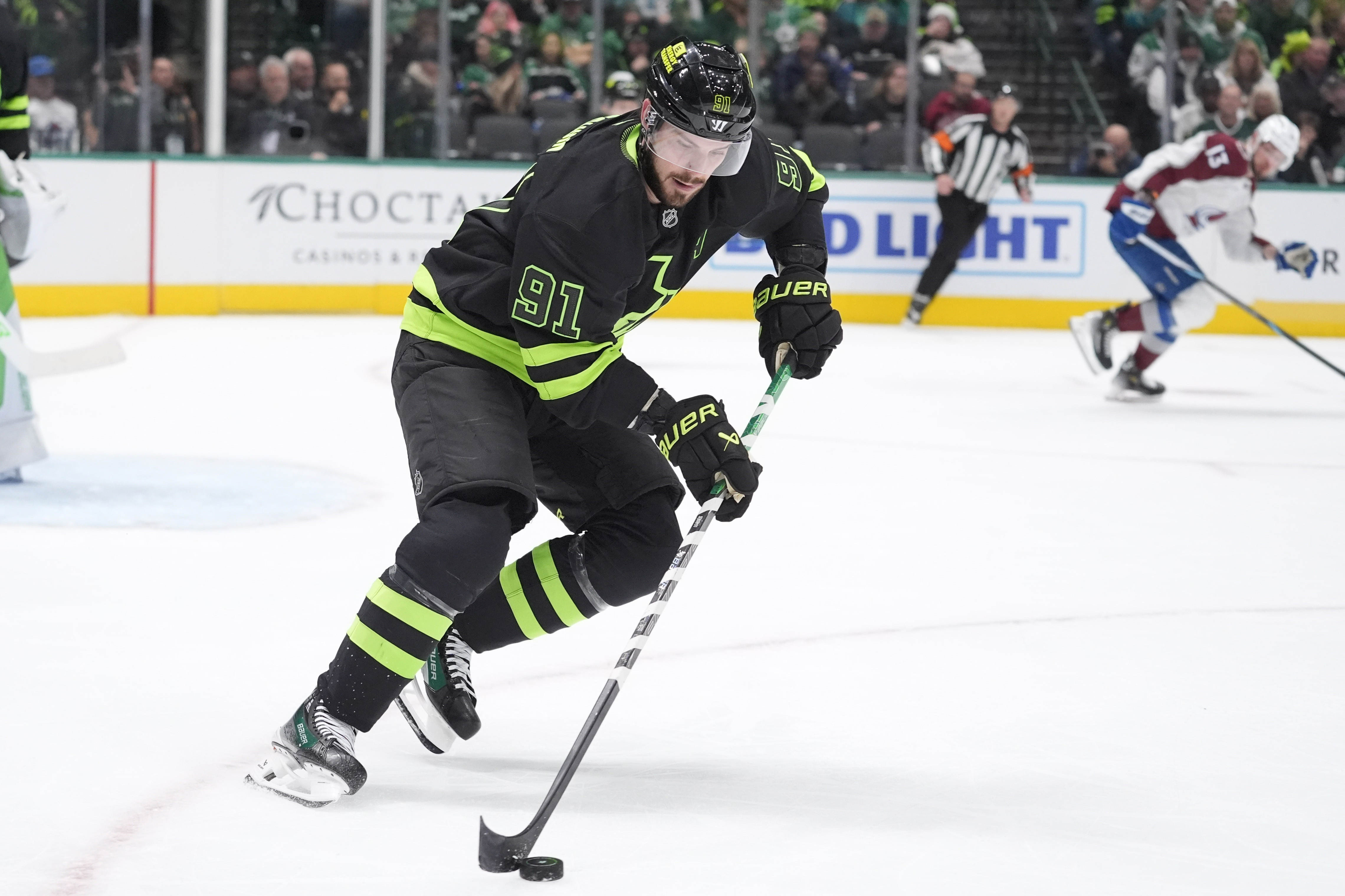 Dallas Stars center Tyler Seguin (91) skates with the puck during the second period of an NHL hockey game against the Colorado Avalanche, Friday, Nov. 29, 2024, in Dallas.