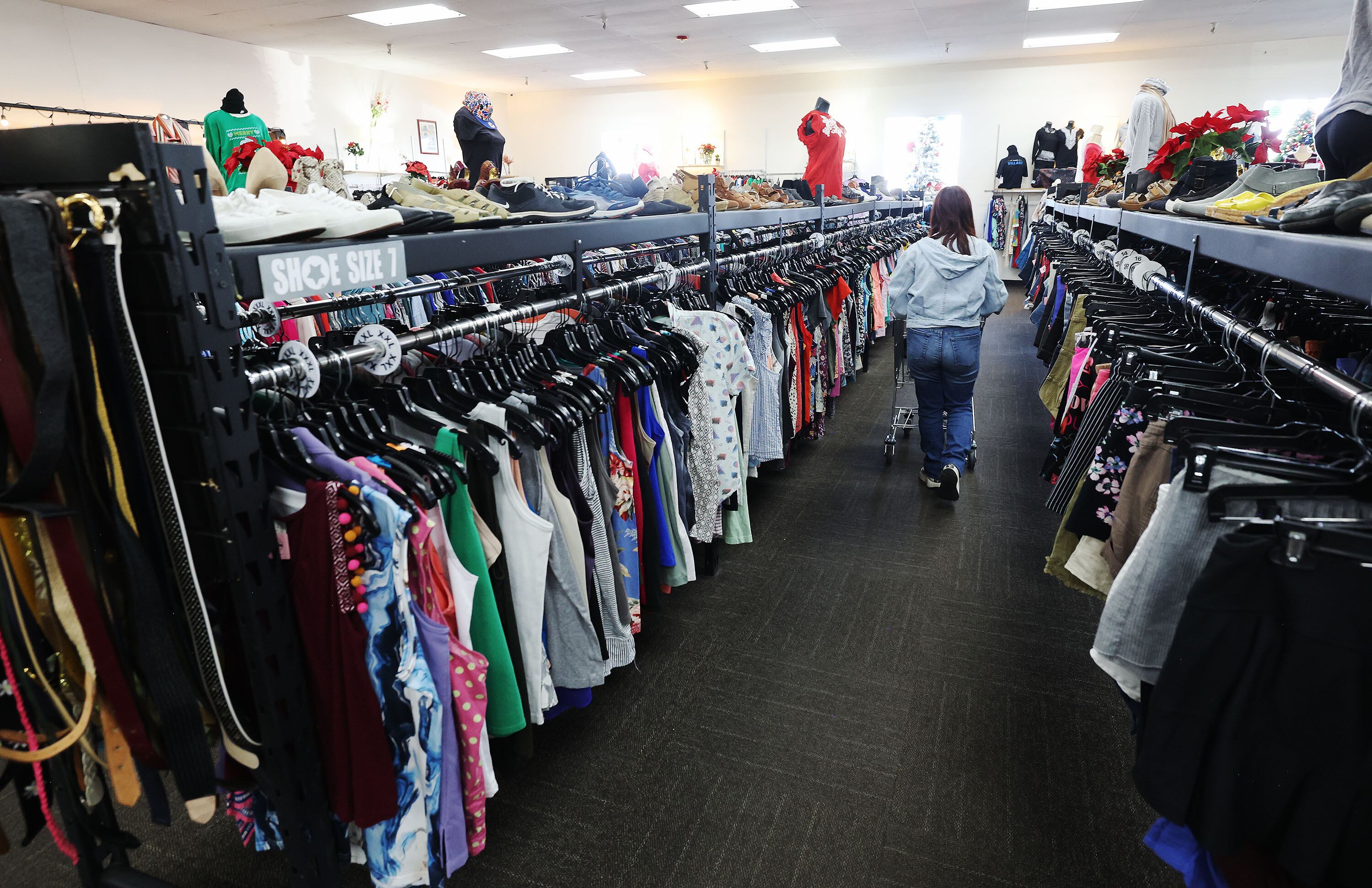 A shopper looks at clothing at the Other Side Academy in Murray on Tuesday.