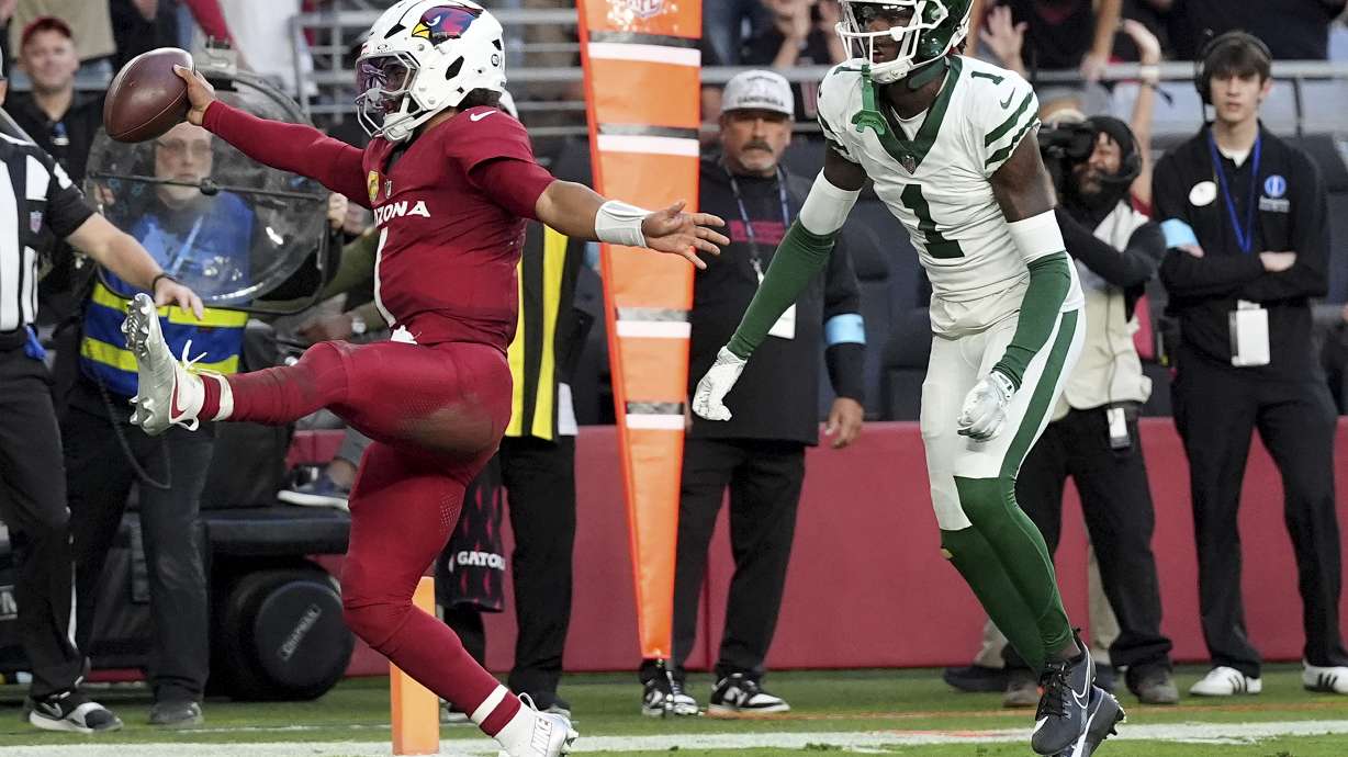 Arizona Cardinals quarterback Kyler Murray, left, scores a touchdown as New York Jets cornerback Sauce Gardner (1) defends during the second half of an NFL football game, Sunday, Nov. 10, 2024, in Glendale, Ariz.