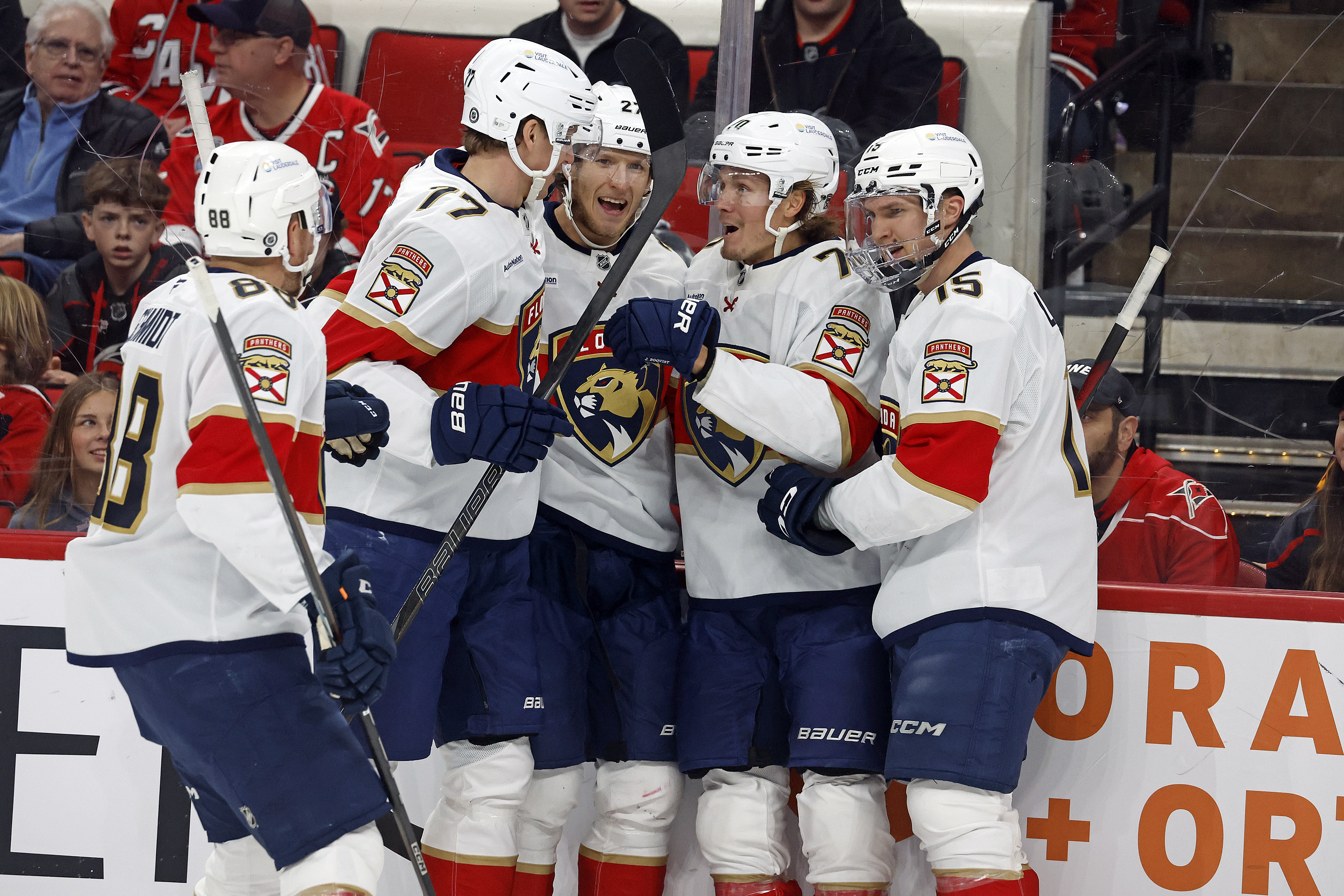 Florida Panthers' Jesper Boqvist, second right, celebrates his goal with Eetu Luostarinen (27), Evan Rodrigues (17), Nate Schmidt (88) and Anton Lundell (15) during the first period of an NHL hockey game against the Carolina Hurricanes in Raleigh, N.C., Friday, Nov. 29, 2024.
