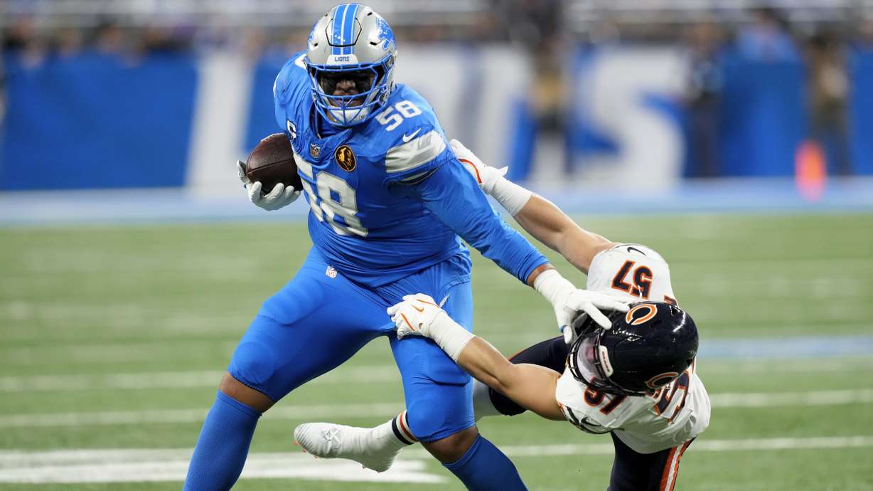 Detroit Lions offensive tackle Penei Sewell (58) sheds the tackle of Chicago Bears linebacker Jack Sanborn (57) during the first half of an NFL football game, Thursday, Nov. 28, 2024, in Detroit.