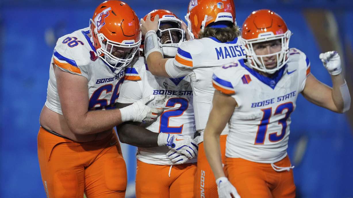 Boise State running back Ashton Jeanty (2) is congratulated by offensive lineman Ben Dooley, left, and quarterback Maddux Madsen after scoring a touchdown against San Jose State during the second half of an NCAA college football game Saturday, Nov. 16, 2024, in San Jose, Calif.
