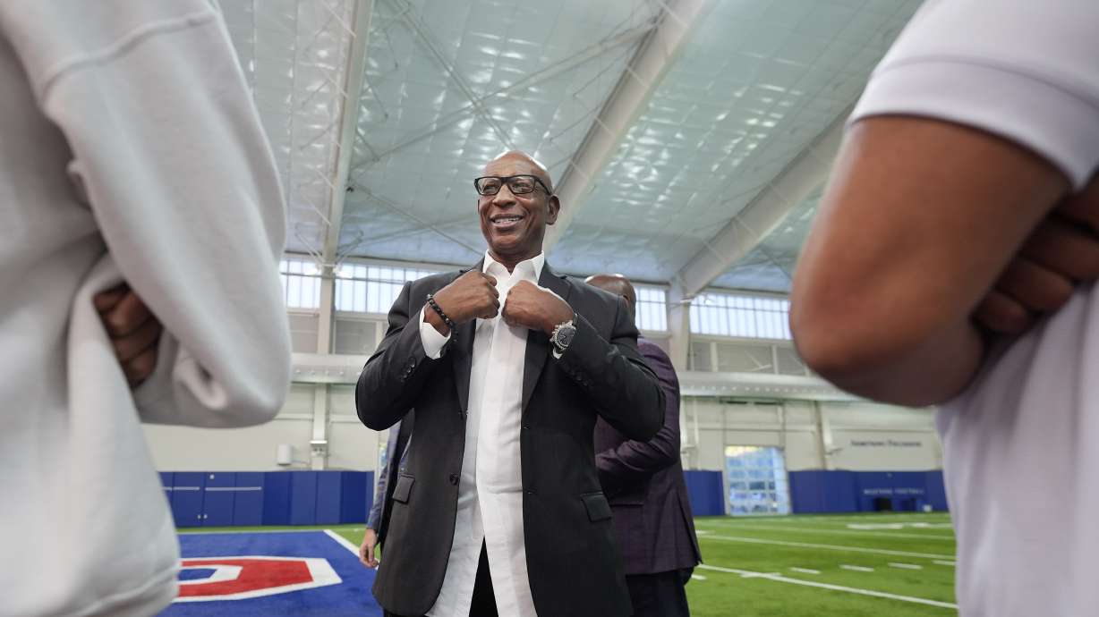 Former NFL and SMU running back Eric Dickerson chats after a panel discussion about NIL and NCAA college football, Tuesday, Dec. 3, 2024, in Dallas.