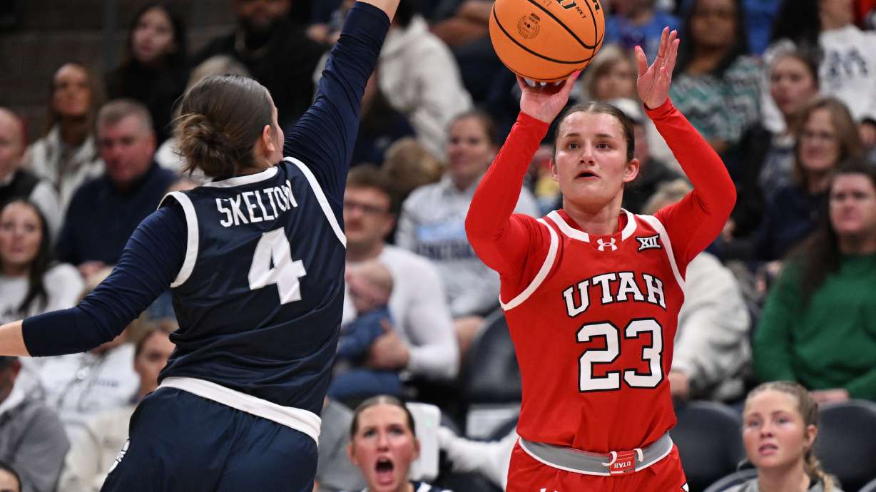Utah Utes guard Matyson Wilke (23) shoots over Utah State Aggies guard Denae Skelton (4) as Utah and Utah State women play at the Delta Center in Salt Lake City on Wednesday, Dec. 4, 2024.
