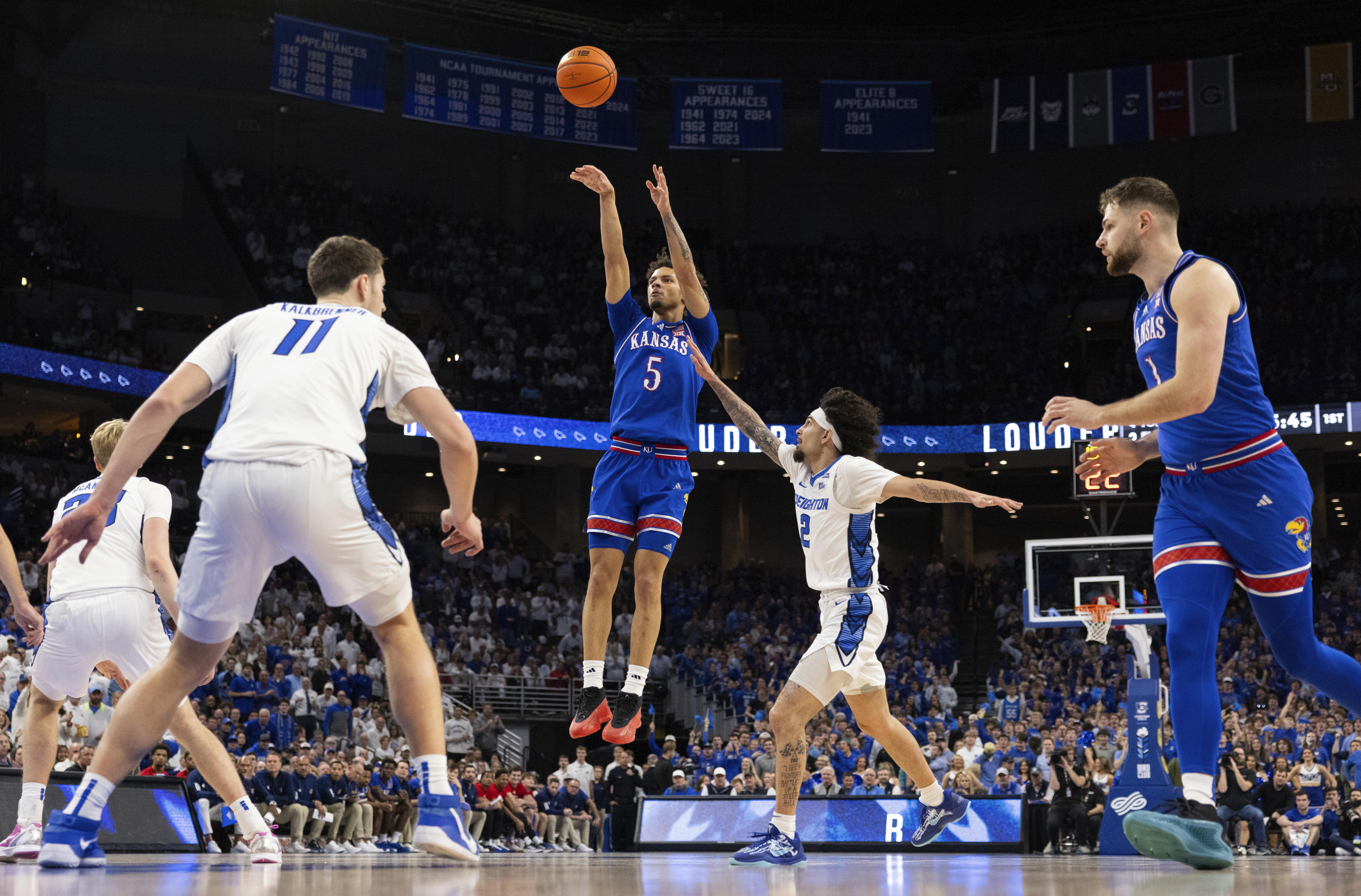 Kansas' Zeke Mayo (5) shoots against Creighton's Pop Isaacs (2) during the first half of an NCAA college basketball game Wednesday, Dec. 4, 2024, in Omaha, Neb.