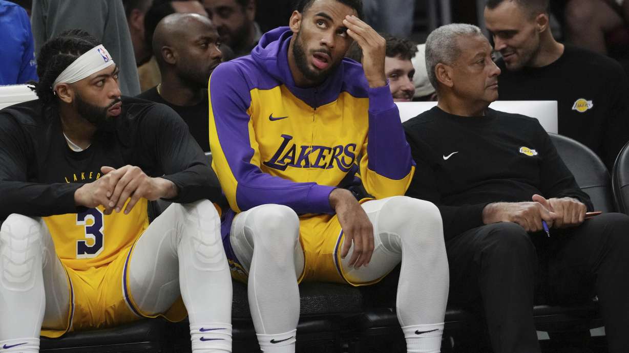 Los Angeles Lakers forward Armel Traore looks up at the score as the team falls behind during the second half of an NBA basketball game against the Miami Heat, Wednesday, Dec. 4, 2024, in Miami.