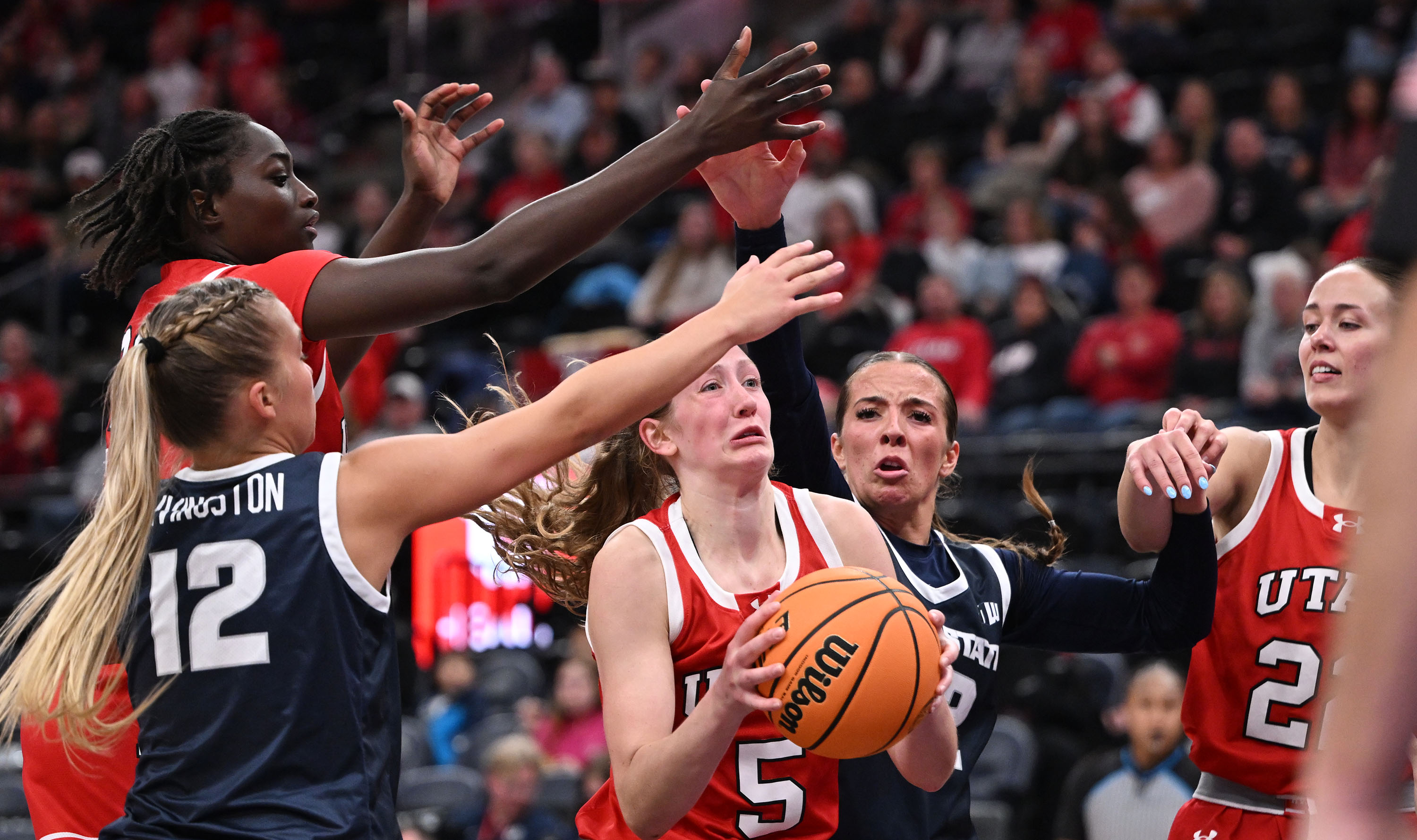 Utah Utes guard Gianna Kneepkens (5) drives into the paint on a shot attempt as Utah and Utah State women play at the Delta Center in Salt Lake City on Wednesday Dec. 4, 2024.