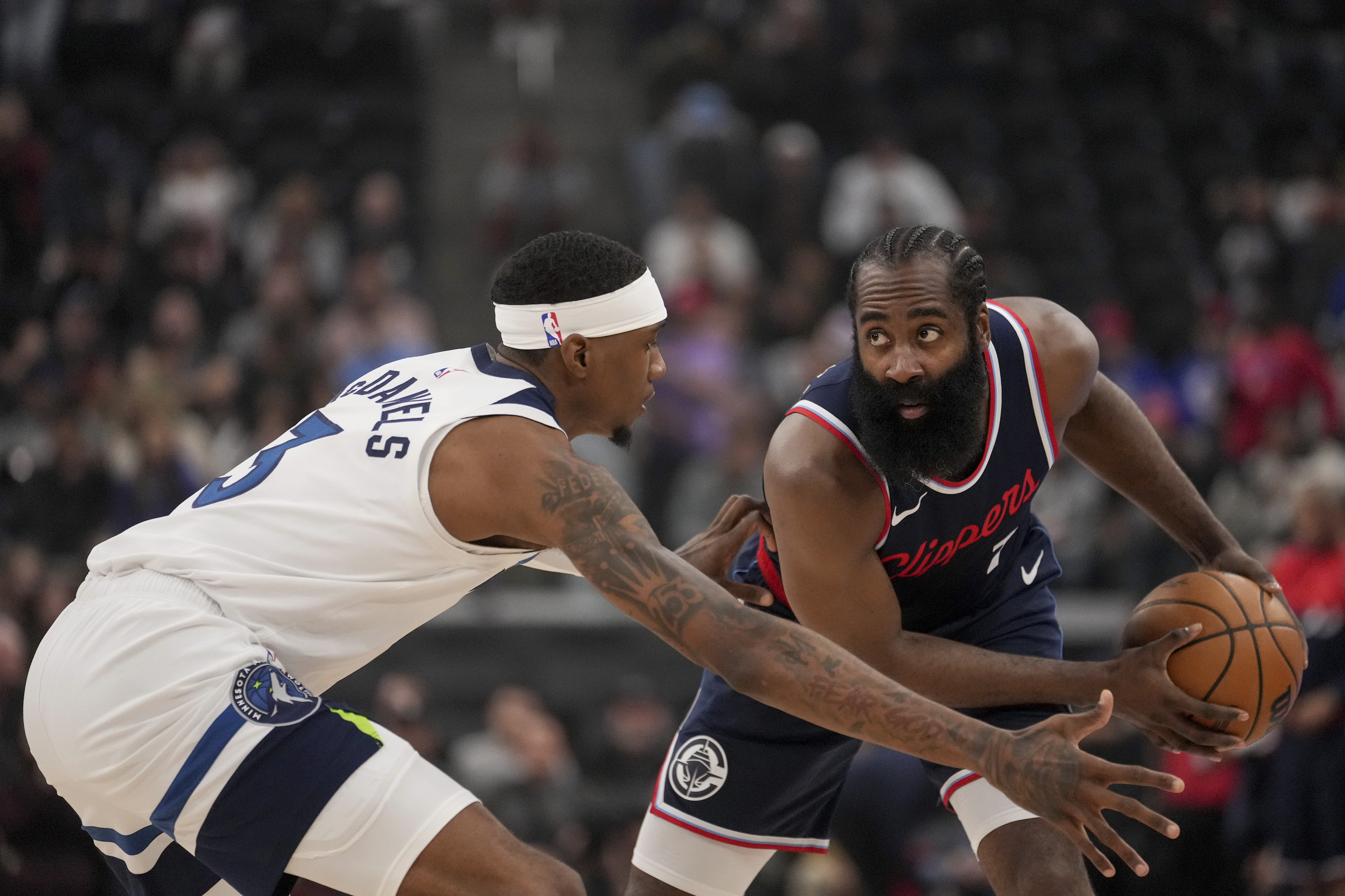 Los Angeles Clippers guard James Harden holds the ball against Minnesota Timberwolves forward Jaden McDaniels during the first half of an NBA basketball game in Los Angeles, Wednesday, Dec. 4, 2018. 