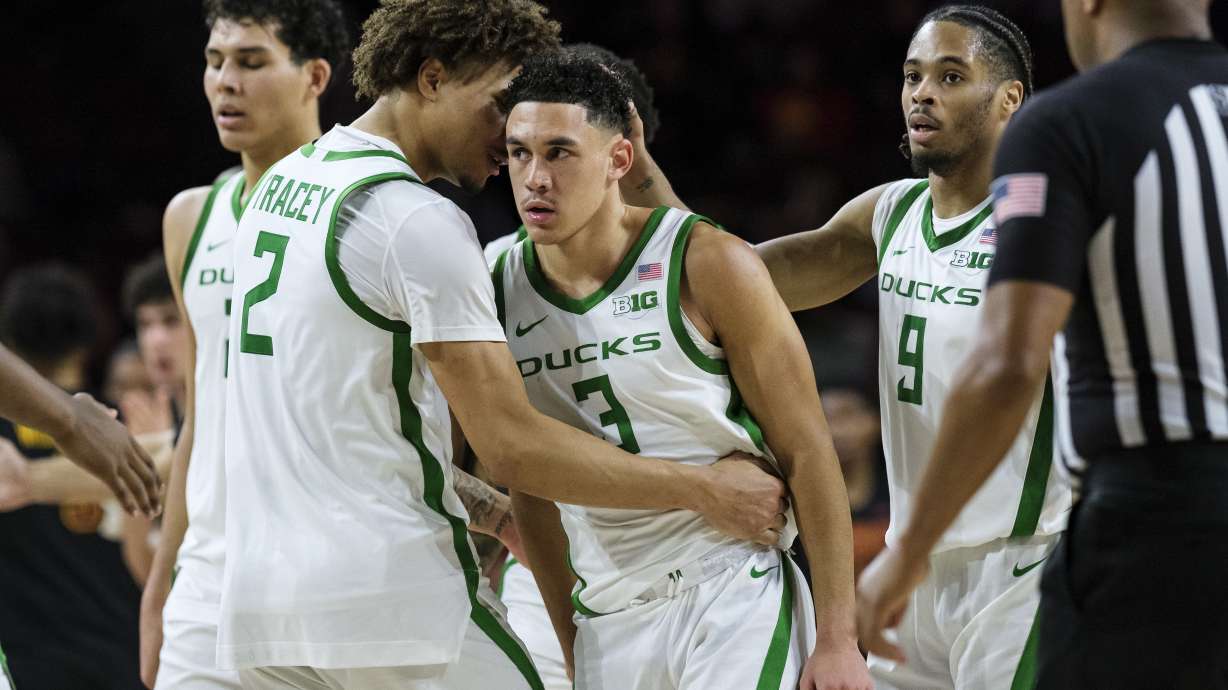 Oregon guard Jackson Shelstad (3) celebrates with the team after making a 3-point-shot during the second half of an NCAA college basketball game against Southern California, Wednesday, Dec. 4, 2024, in Los Angeles.