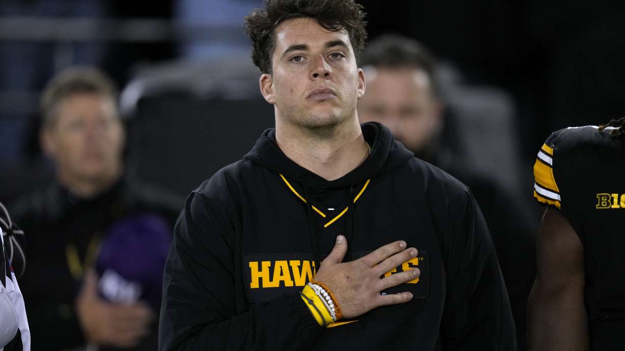FILE -Injured Iowa quarterback Cade McNamara stands on the field before an NCAA college football game against Wisconsin, Nov. 2, 2024, in Iowa City, Iowa.